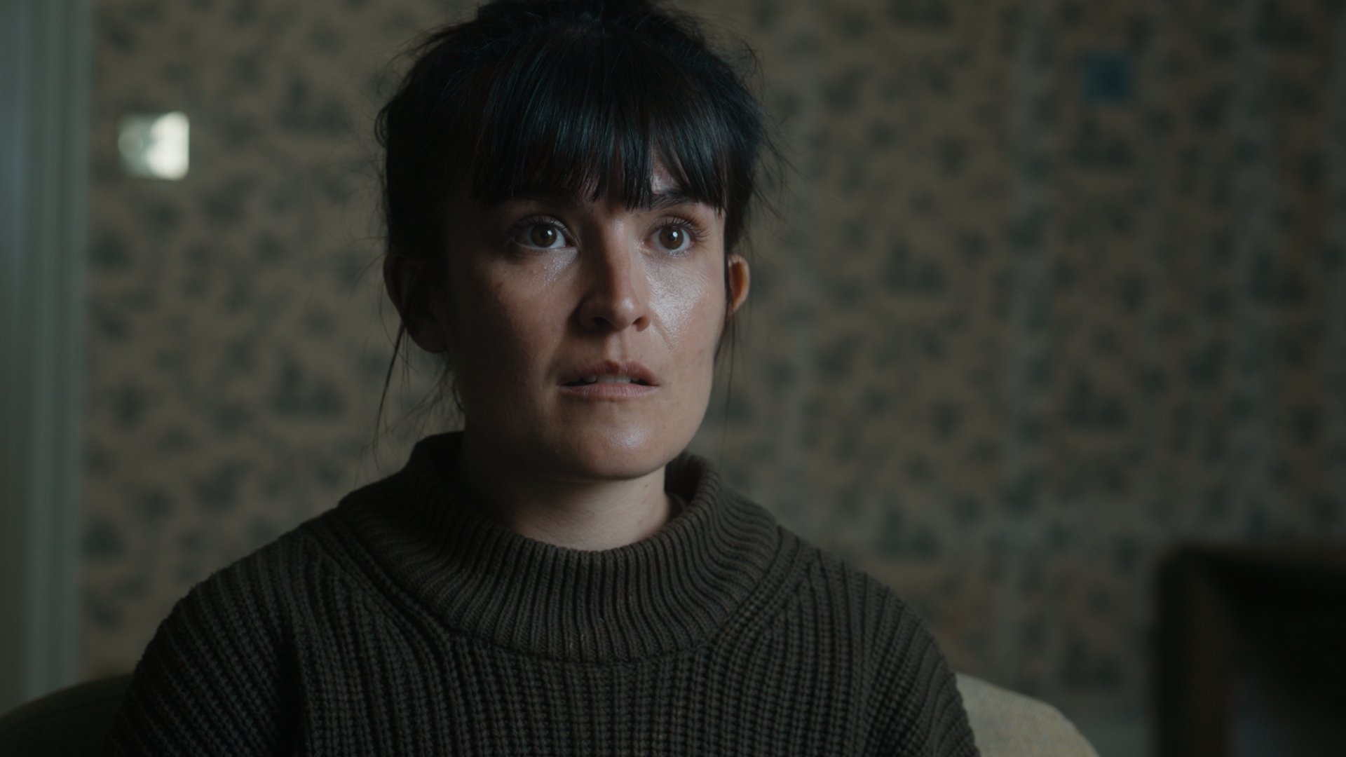 A closeup on a concerned woman.