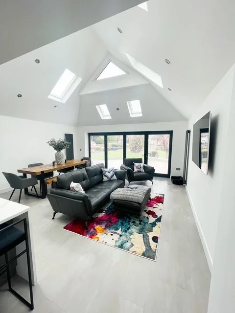 A single - storey burnt larch extension with a Dutch Barn roof and internal remodelling. Kellington East Yorkshire. Great family space.