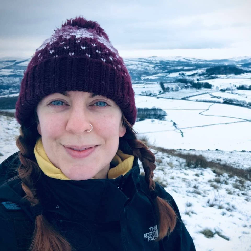 Portrait of Clare outdoors in the Peak District, reflecting on her personal meditation journey and connection to nature.