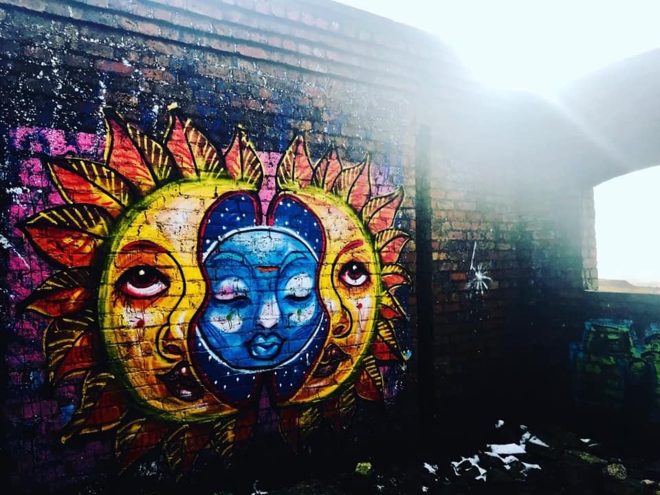 Colourful sun and moon wall art symbolising balance, reflection and meditation, photographed in the Peak District.