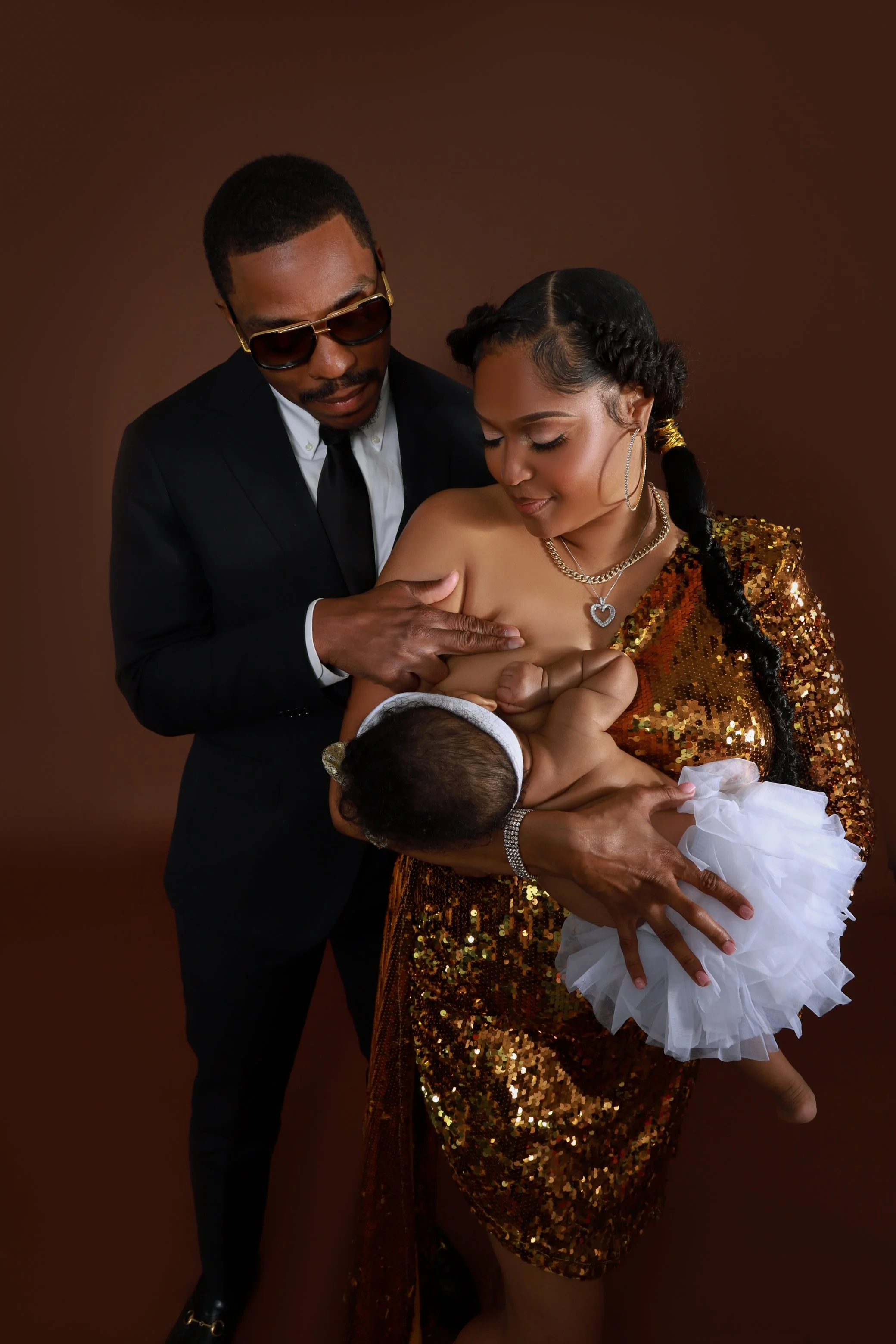 Parents breastfeeding a baby