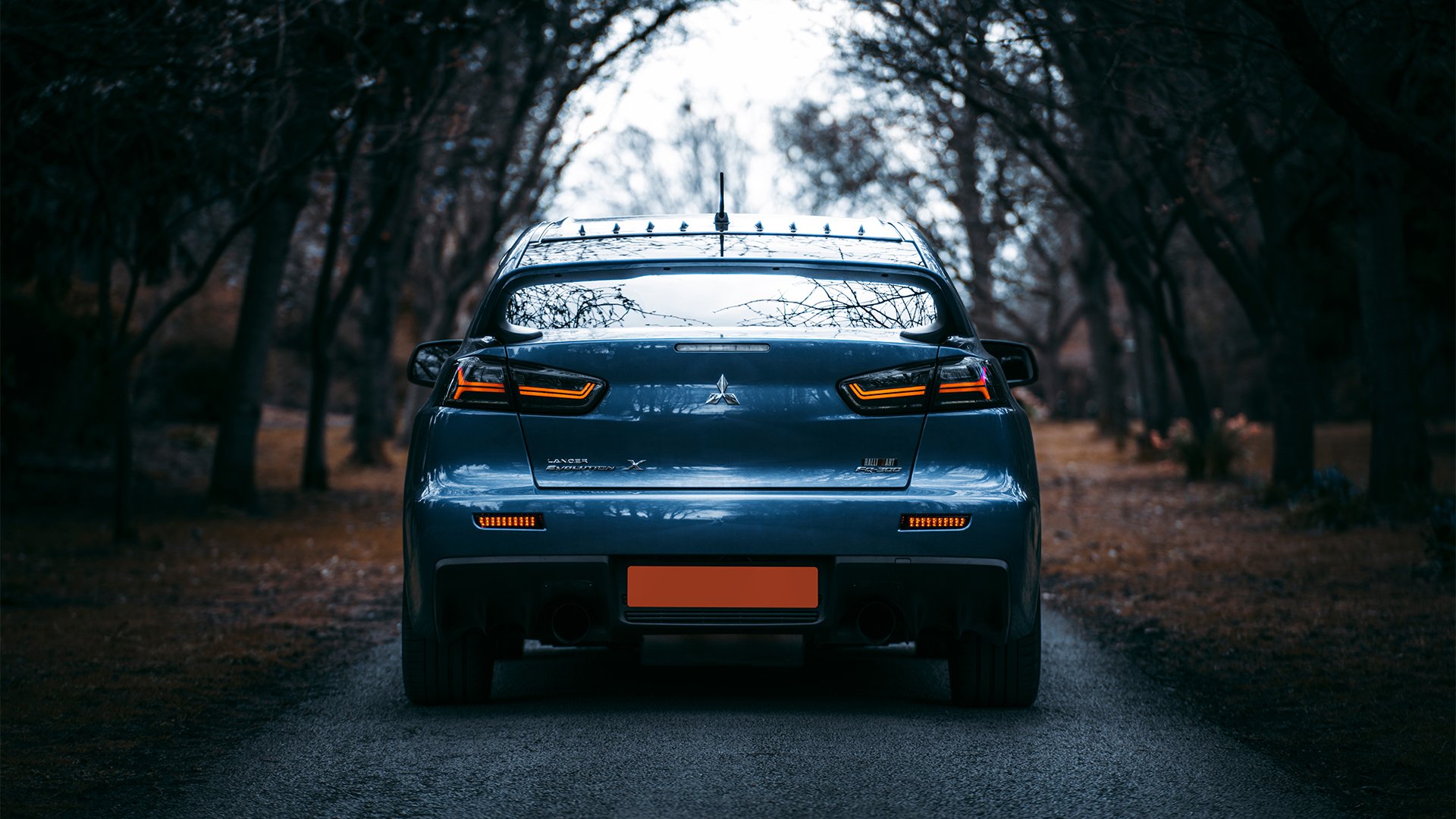 A photo of a Mitsubishi Lancer Evolution X, taken by Liamoxoart
