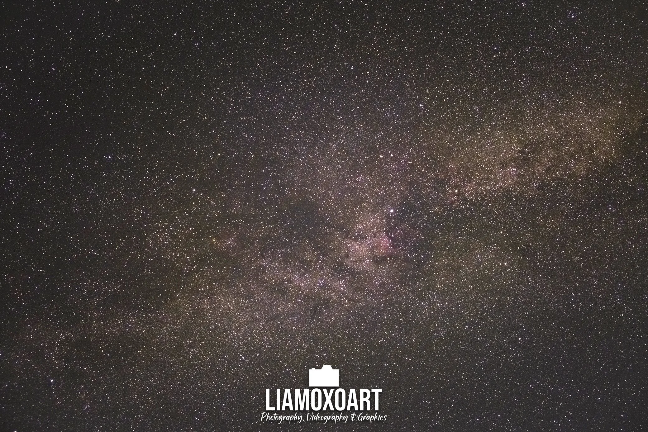 A starry night sky with numerous stars and the Milky Way galaxy visible. There is a white logo and text at the bottom that reads 'LIAMOXOART Photography, Videography & Graphics'.