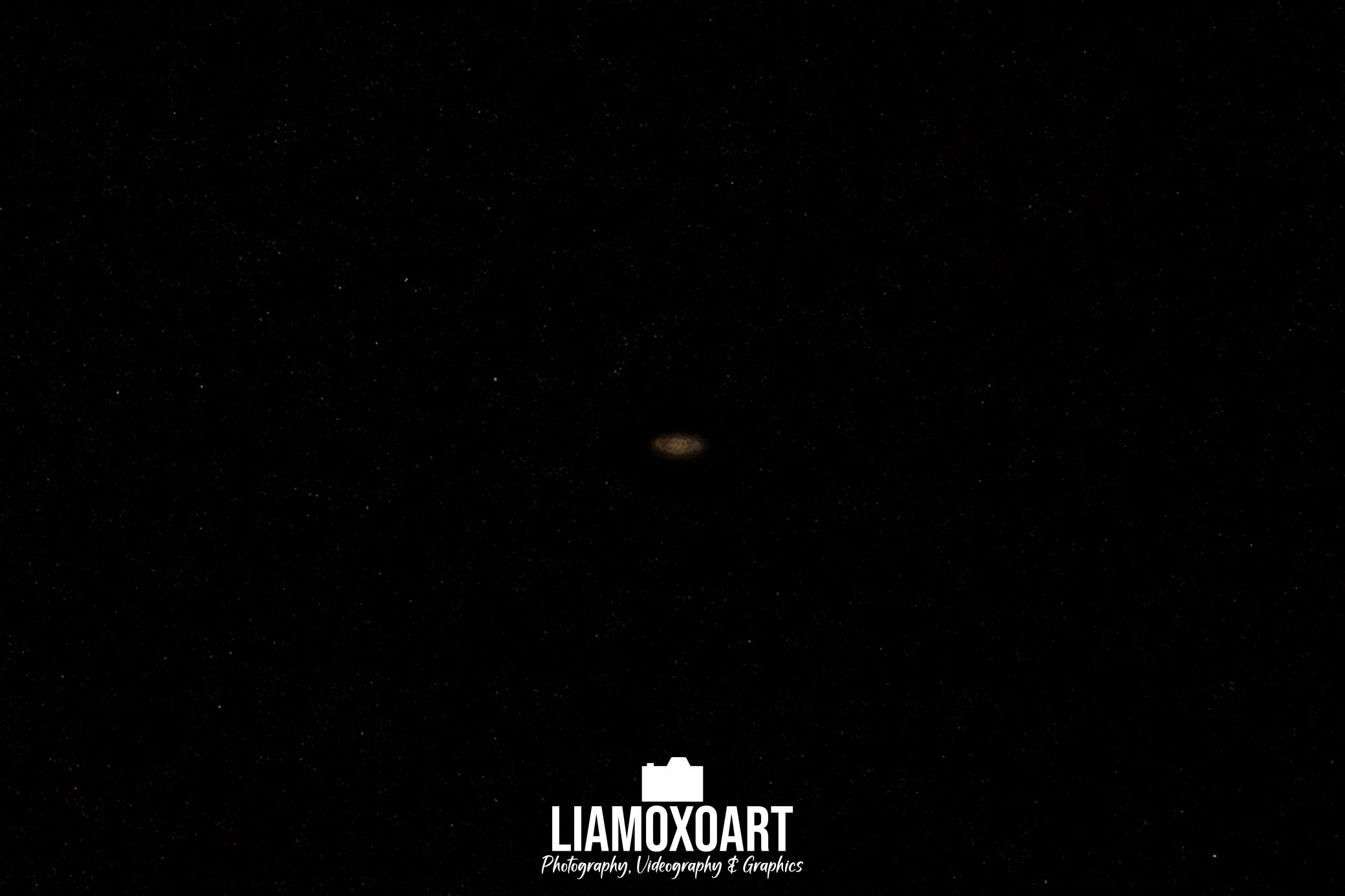 Night sky filled with stars with a small landing page text overlay reading "LIAMOXOART" along with the description "Photography, Videography & Graphics."