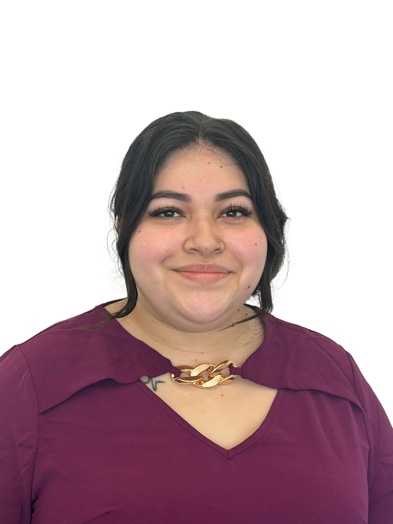 Young woman with long dark hair, makeup, and a red top, sitting inside a vehicle, looking at the camera.