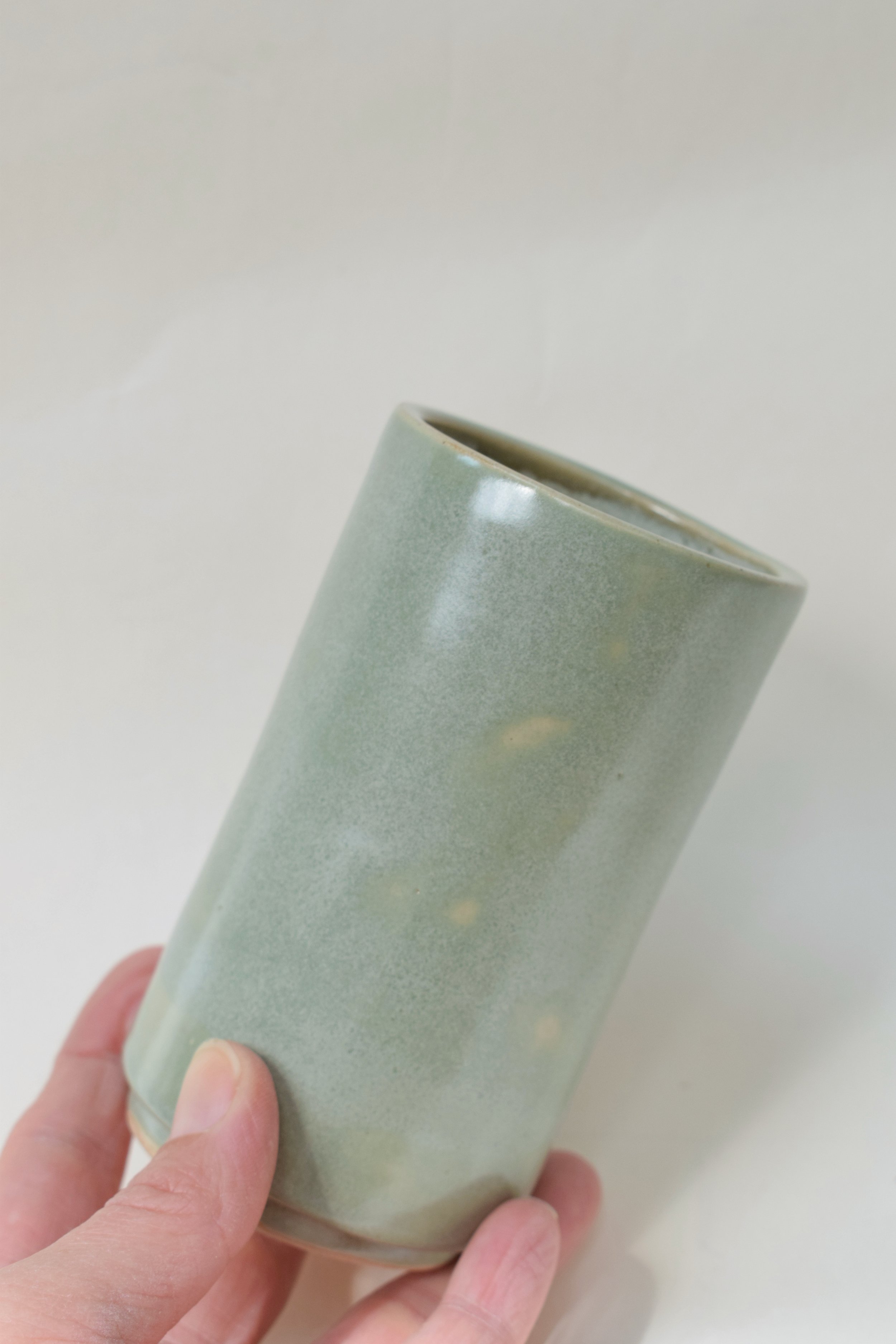 J Lucas Pottery_sage green small vase_held.jpeg