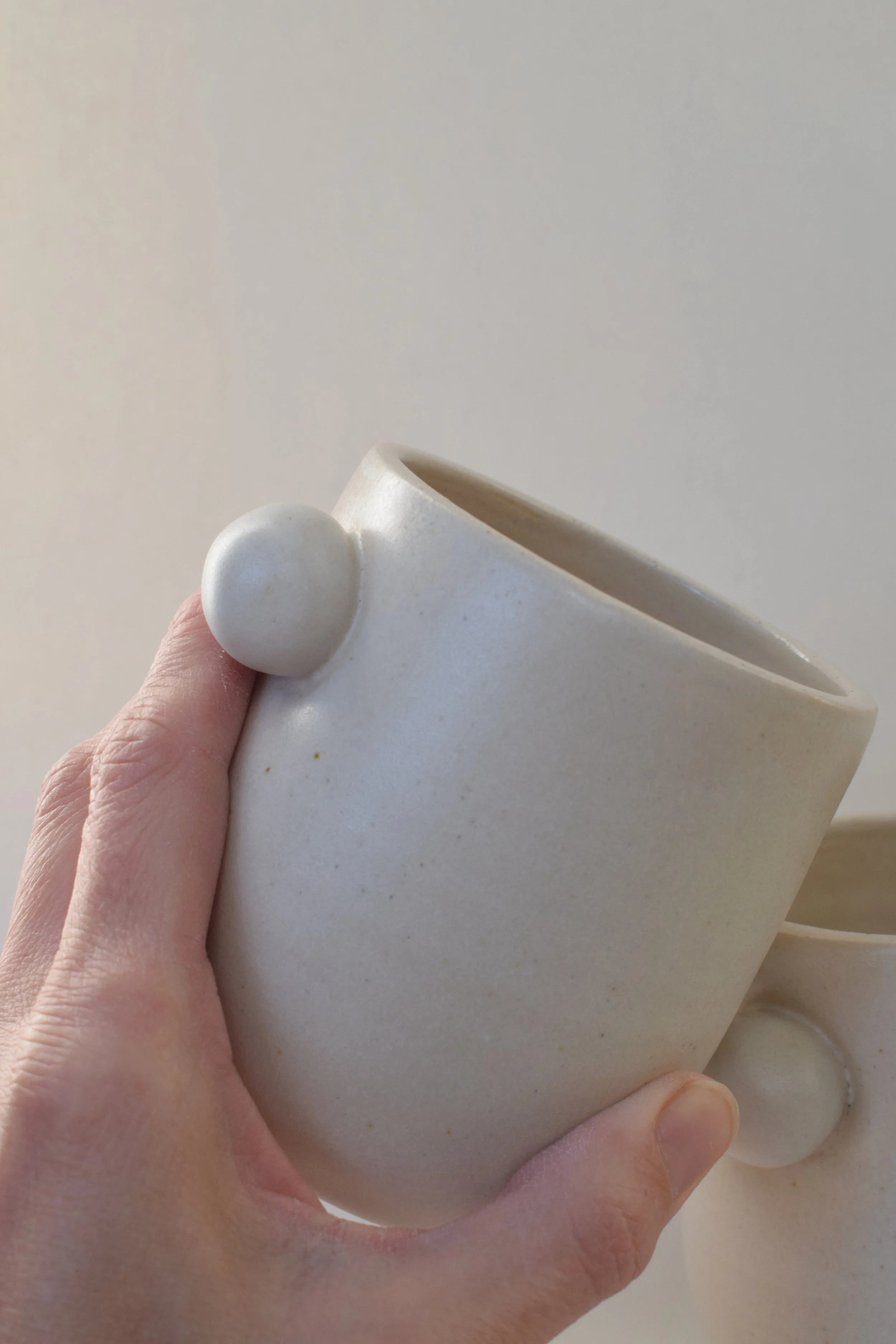 J Lucas Pottery_cotton bobble cup_held.jpeg