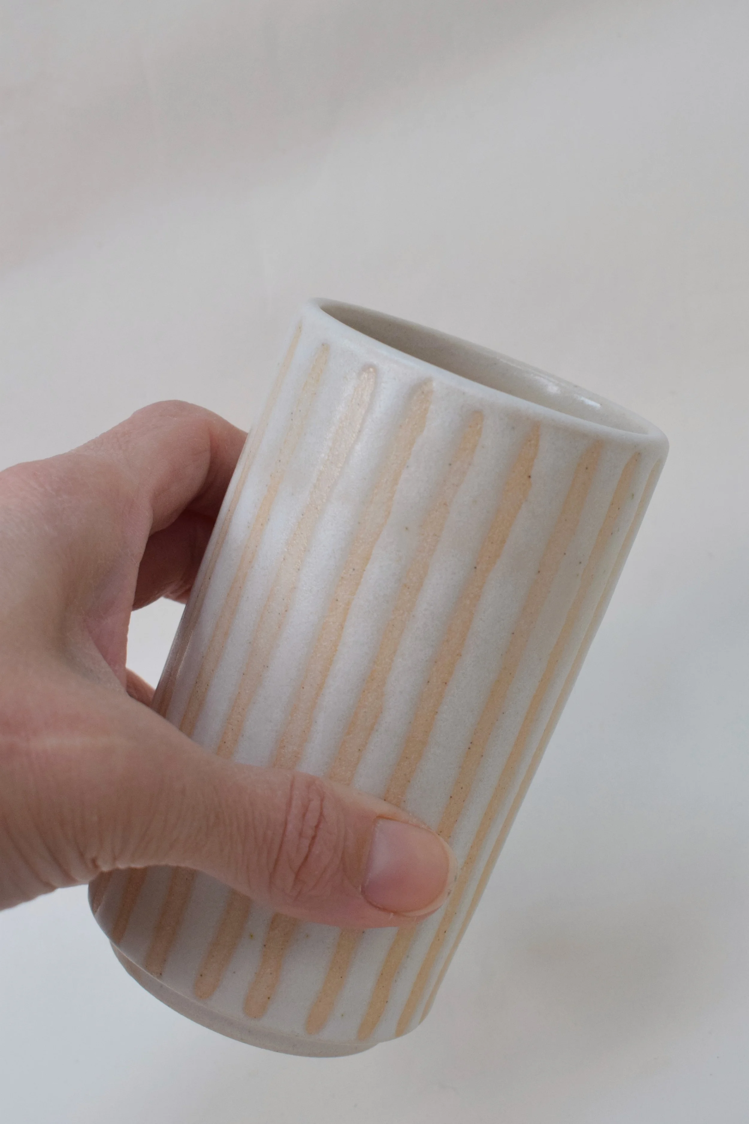 J Lucas Pottery_cotton stripe small vase_held.jpeg