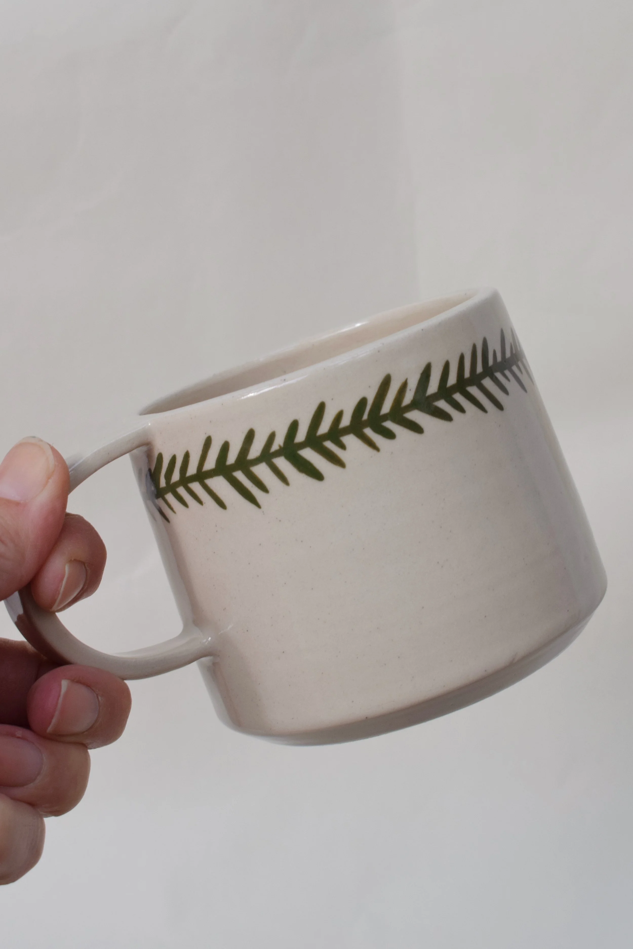 J Lucas Pottery_frond mug_held.jpeg