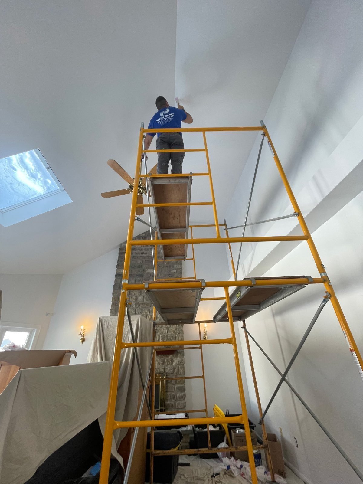 A professional interior painter applying paint to an interior wall