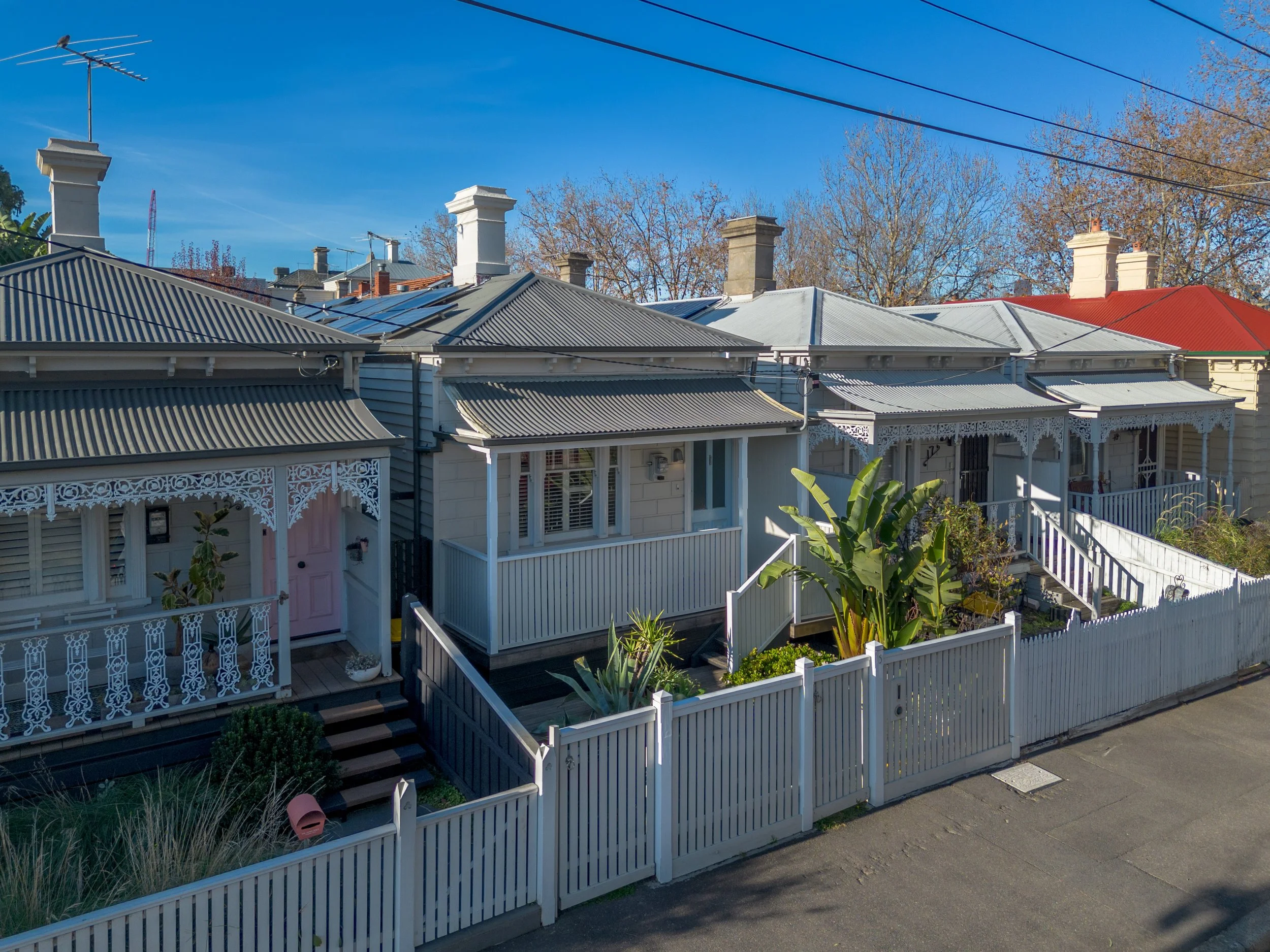Aerial view of a suburban neighborhood showing multiple houses with solar panels on roofs, labeled landmarks including Clyde Cricket Club, Casey Fields, and Coles, with a house marked in the center.