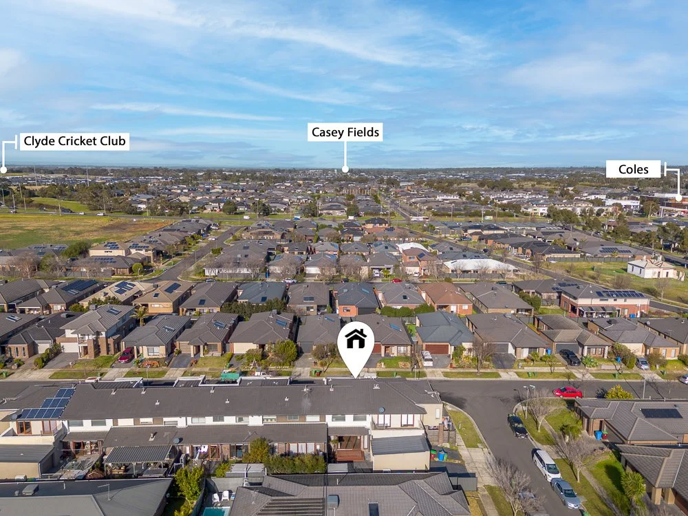 Aerial view of a suburban neighborhood showing multiple houses with solar panels on roofs, labeled landmarks including Clyde Cricket Club, Casey Fields, and Coles, with a house marked in the center.