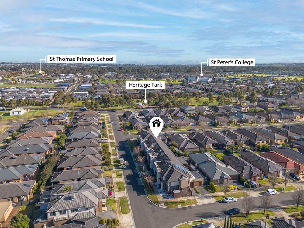 Aerial view of a residential neighborhood with labels pointing to St Thomas Primary School, Heritage Park, and St Peter's College in the background.