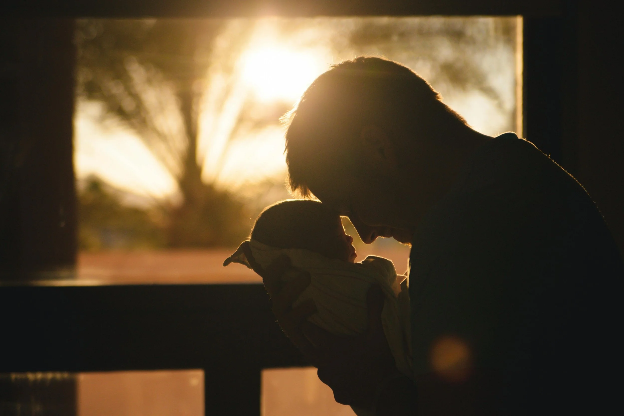 Dad holding baby wondering do I have postpartum anxiety and how long does postpartum anxiety last?