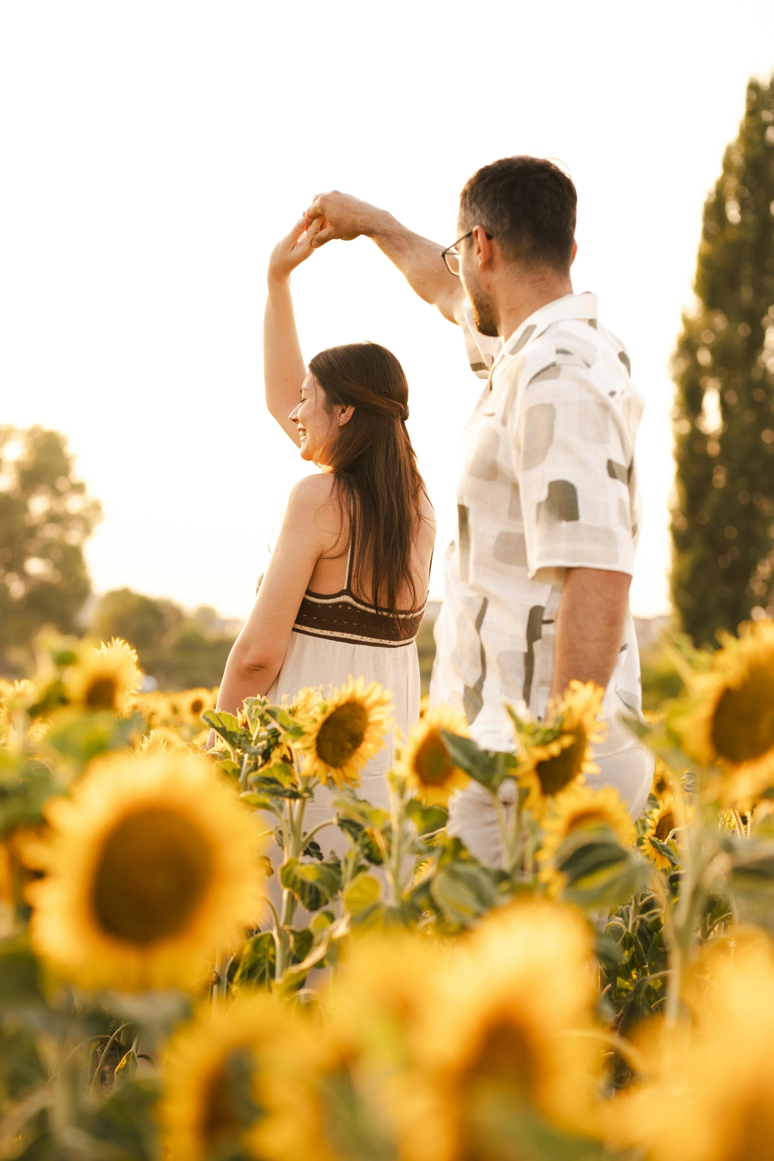 couple among sun flowers wondering how to choose a couples therapist and will couples counseling work