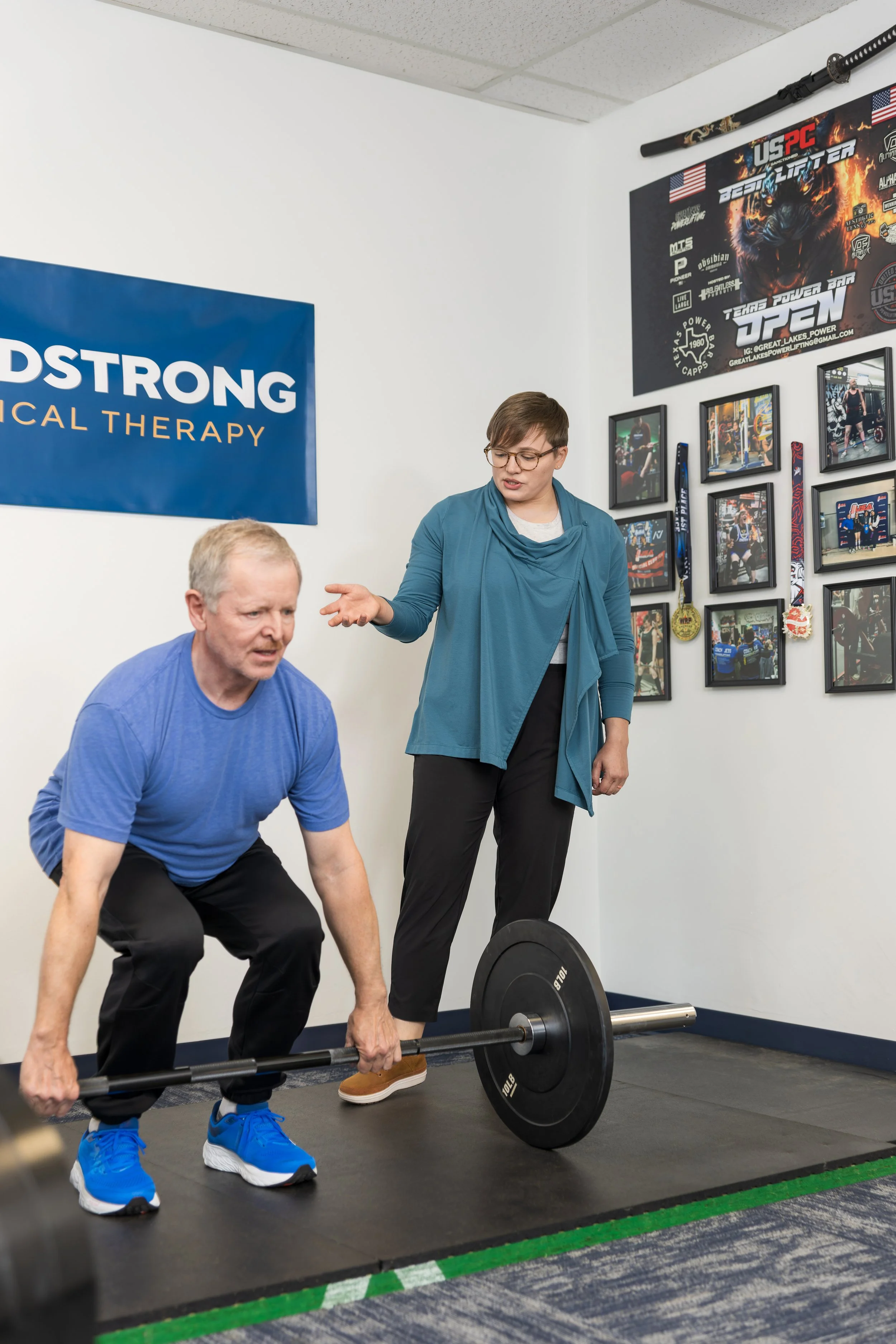 Physical therapist training individual on the deadlift to prepare for return to work.