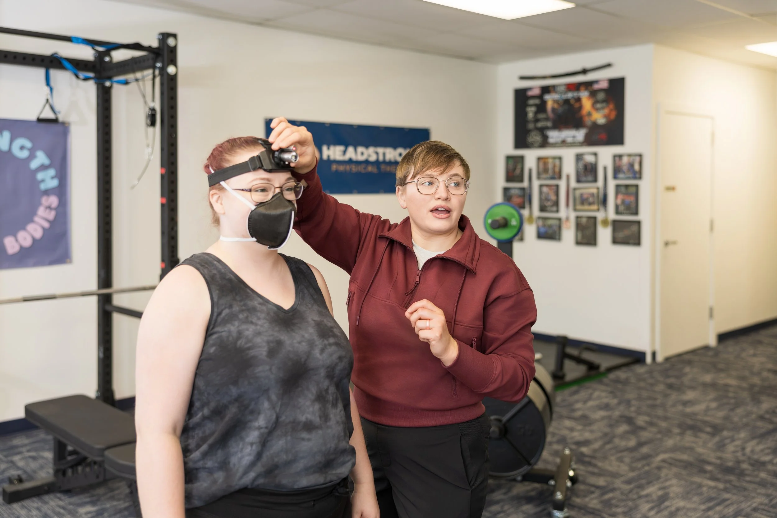 Physical therapist using externally focused exercise to manage functional neurological disorders.