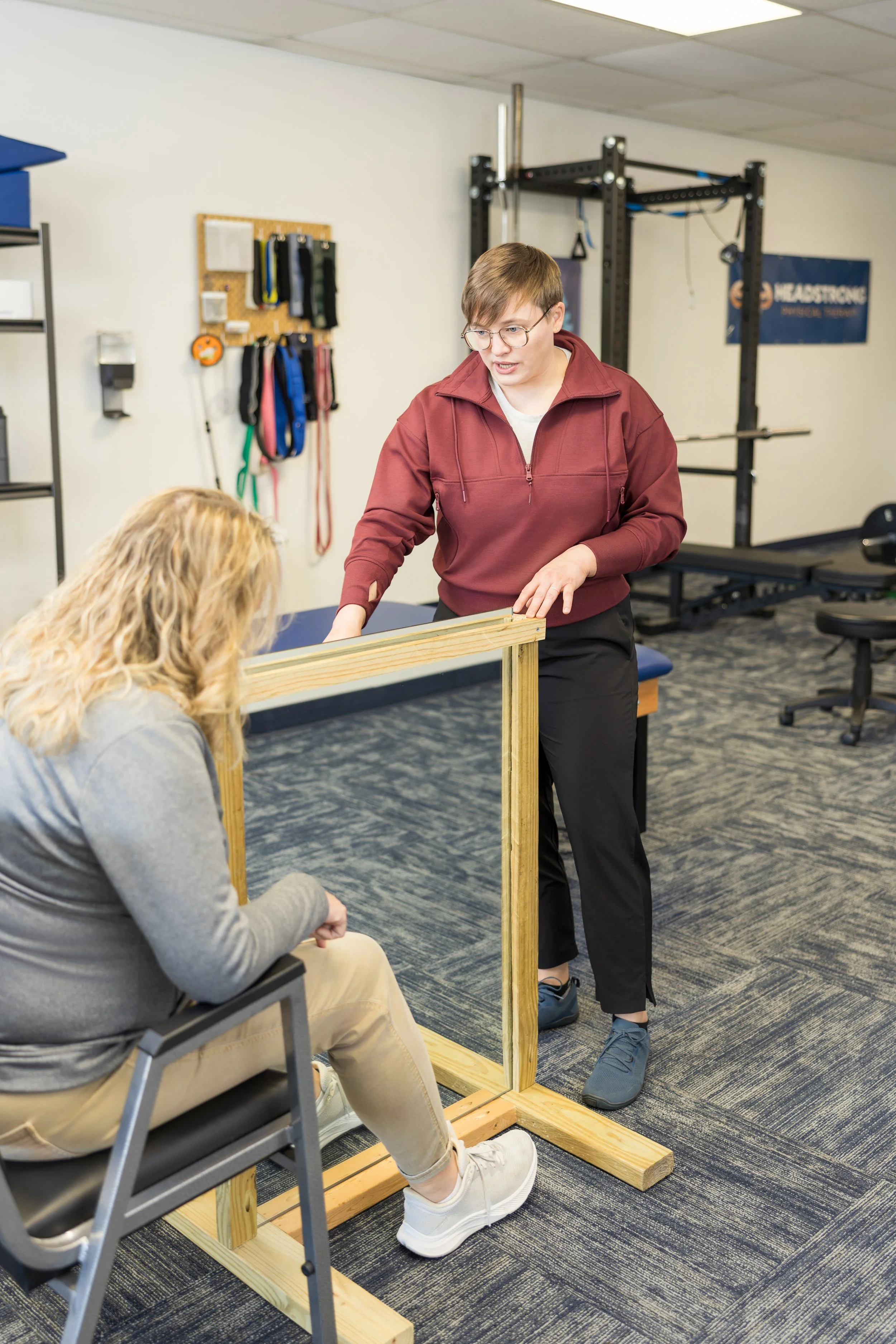 Physical therapist using mirror therapy to improve function after neurological injury.