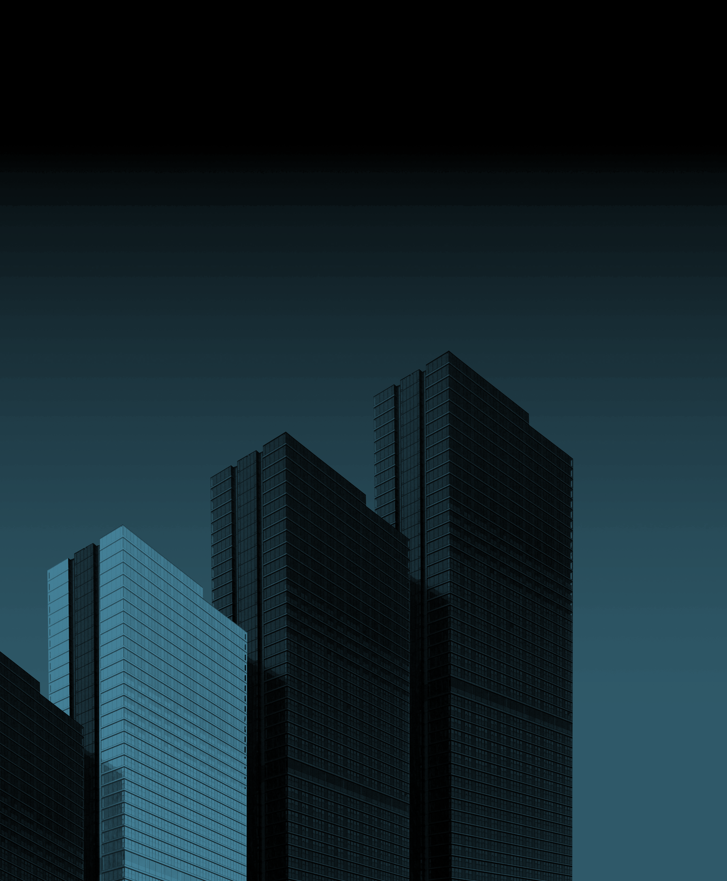 A dark city skyline with tall modern skyscrapers against a gradient sky.