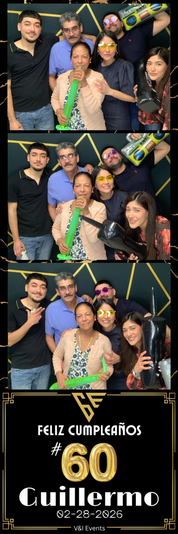 Group of six people celebrating a birthday, with some wearing fun sunglasses and holding party props like a toy guitar, a neon stick, and a boombox, in front of a dark background with gold geometric accents.