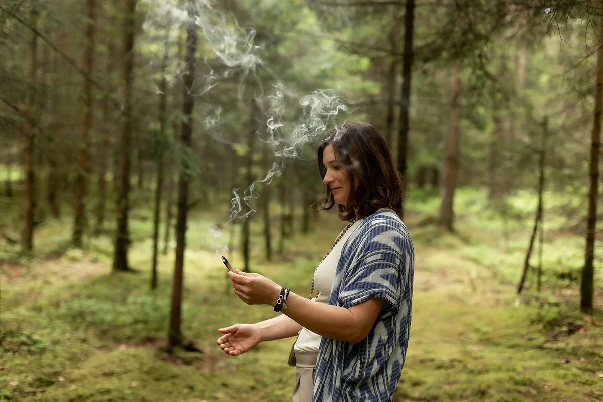 Achtsames Räucherritual mit Palo Santo im Wald, bei dem Rauch in ruhiger Atmosphäre aufsteigt.