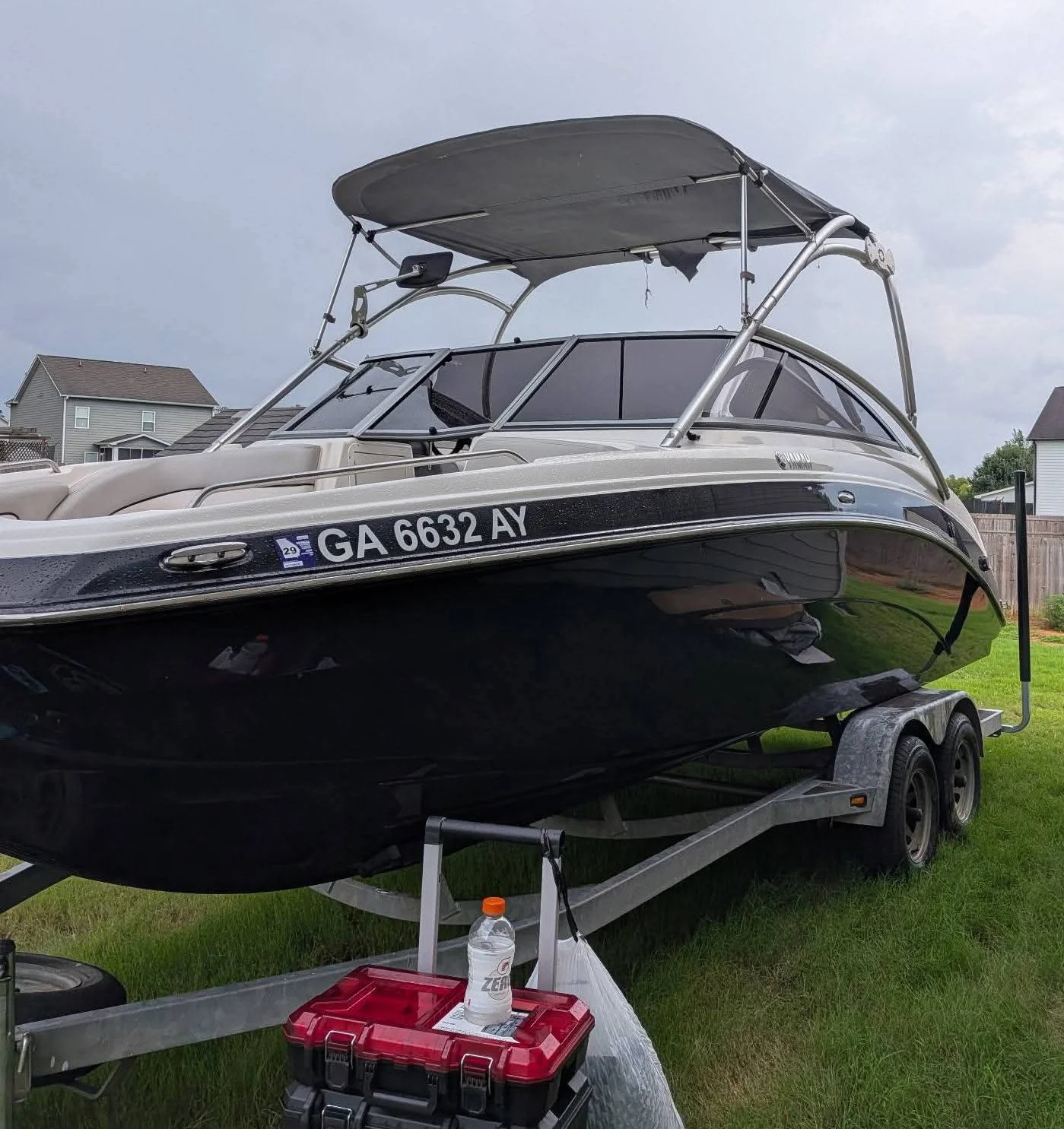 Black recreational powerboat on a trailer with tinted cabin windows, showcasing marine window tinting by Only Shades