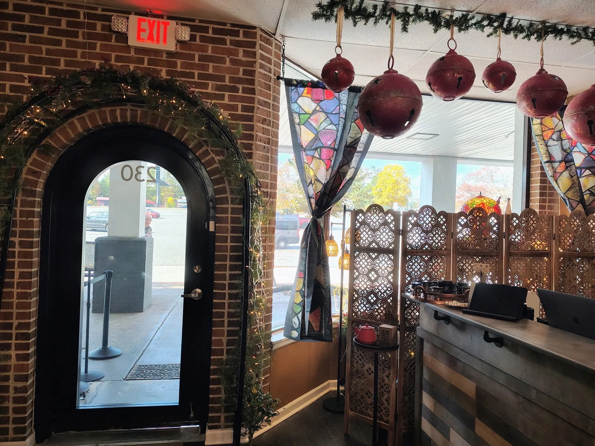Commercial building interior featuring large glass windows and an arched entrance, showcasing window tinting services by Only Shades