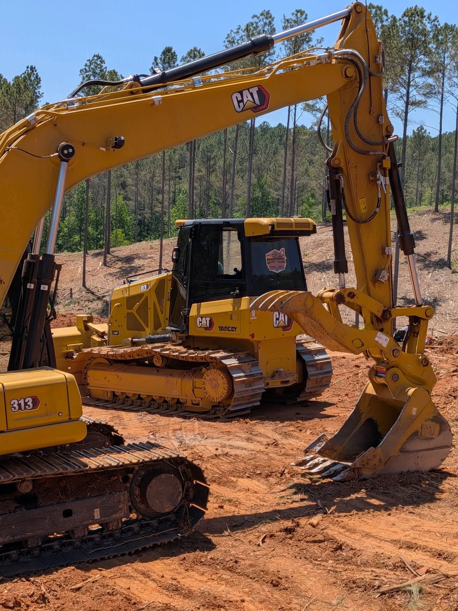 Yellow CAT excavators at a construction site, showcasing heavy equipment window tinting services offered by Only Shades