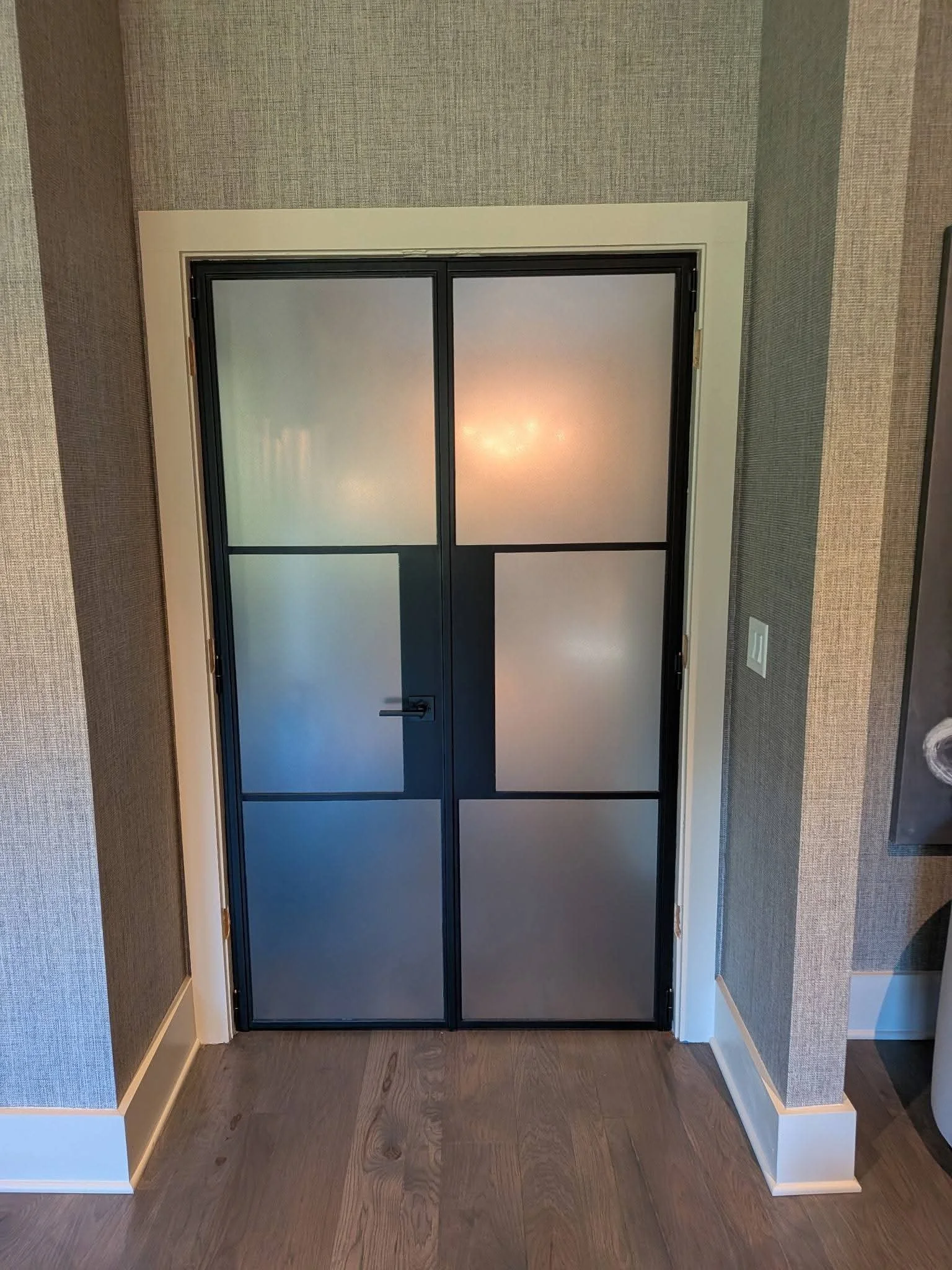 Interior black framed glass doors  with decorative frosted privacy window film installed by Only Shades Mobile Window Tinting