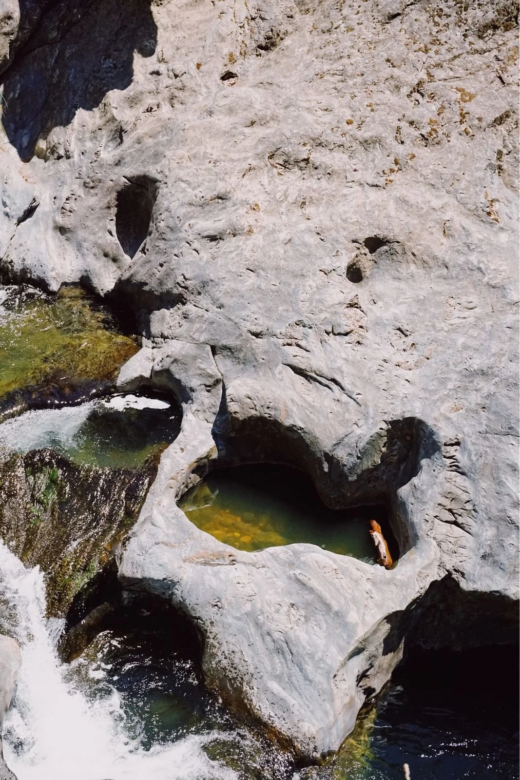 Rock formation with small pools of water and waterfalls