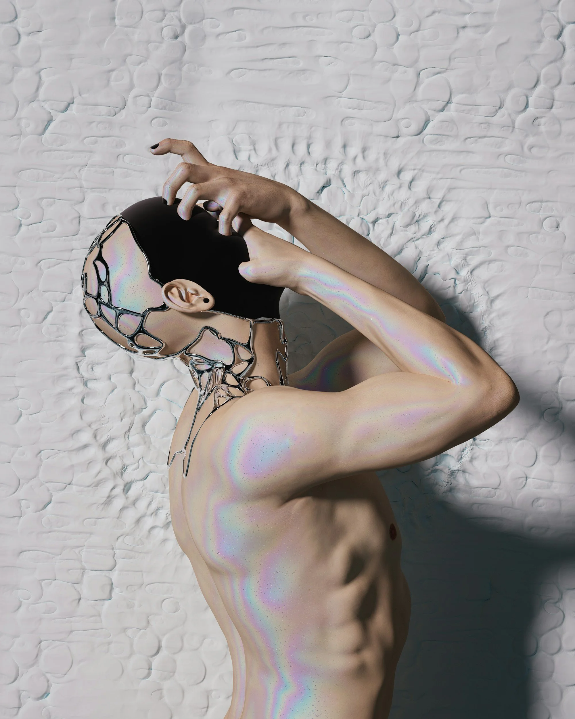 A person lying on a textured white surface with black and iridescent paint or material on their face and neck, partially covering their head, with one arm bent and hand touching the head.