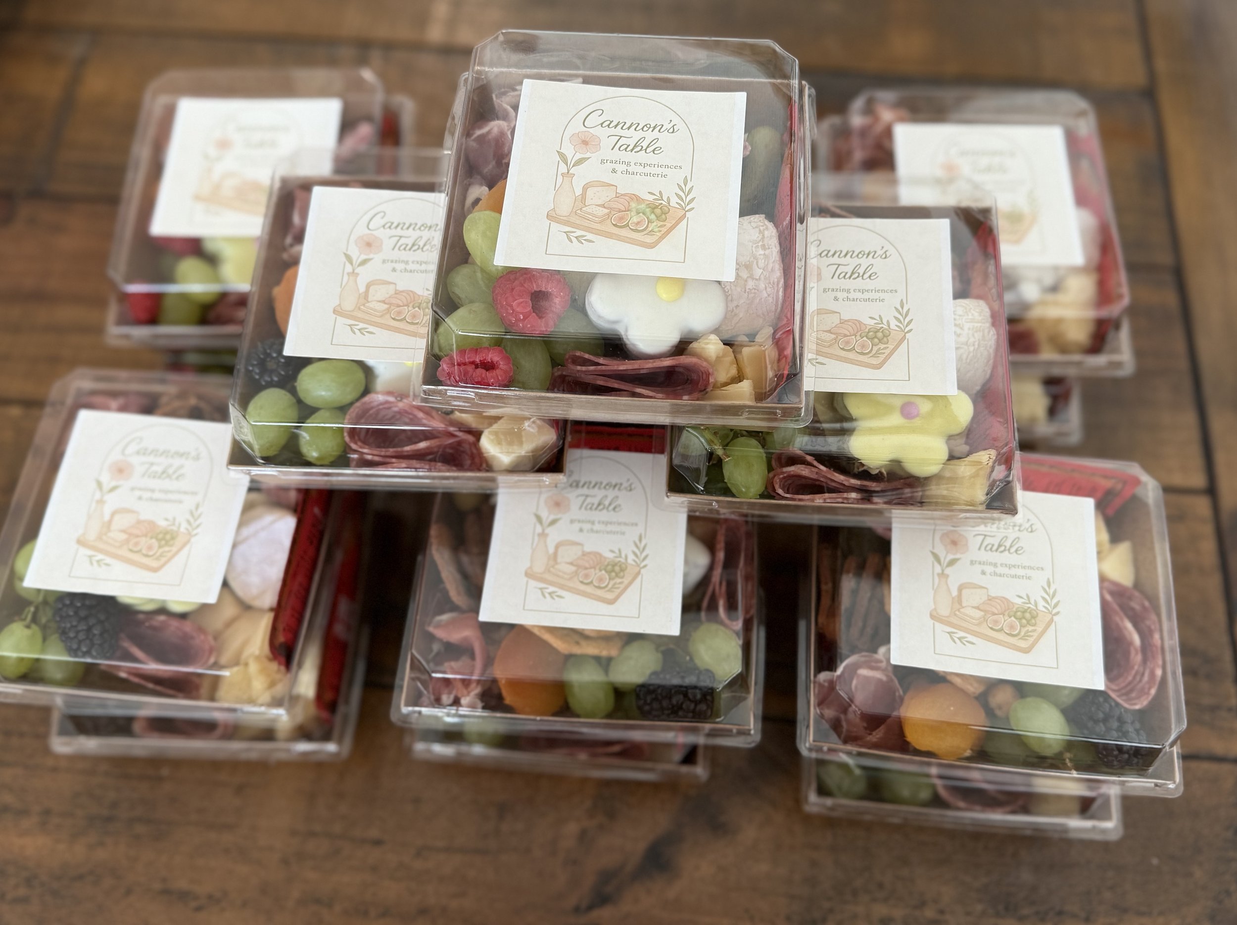 Packaged charcuterie boxes filled with assorted candies, created by Cannon's Table.