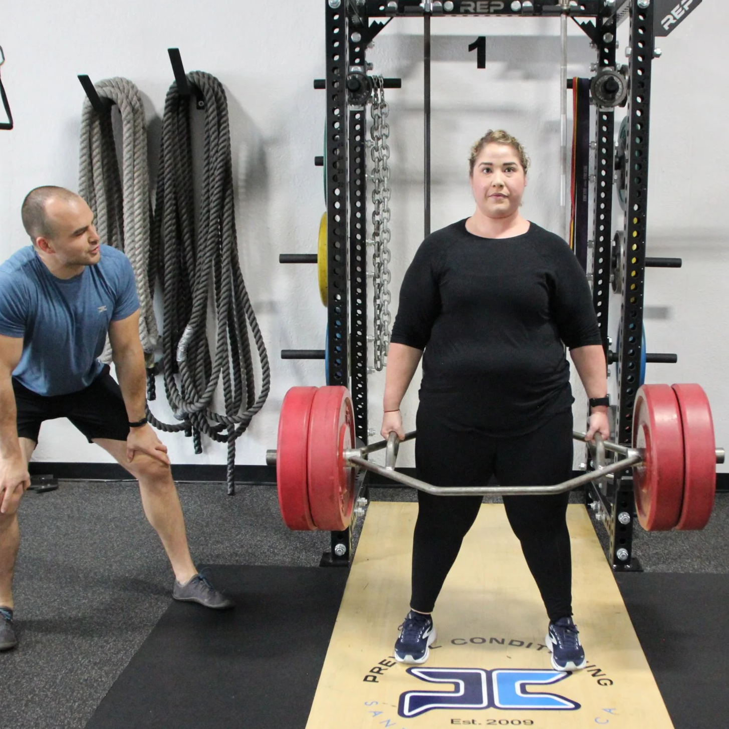 Woman completes a 225 lb. deadlift with ease