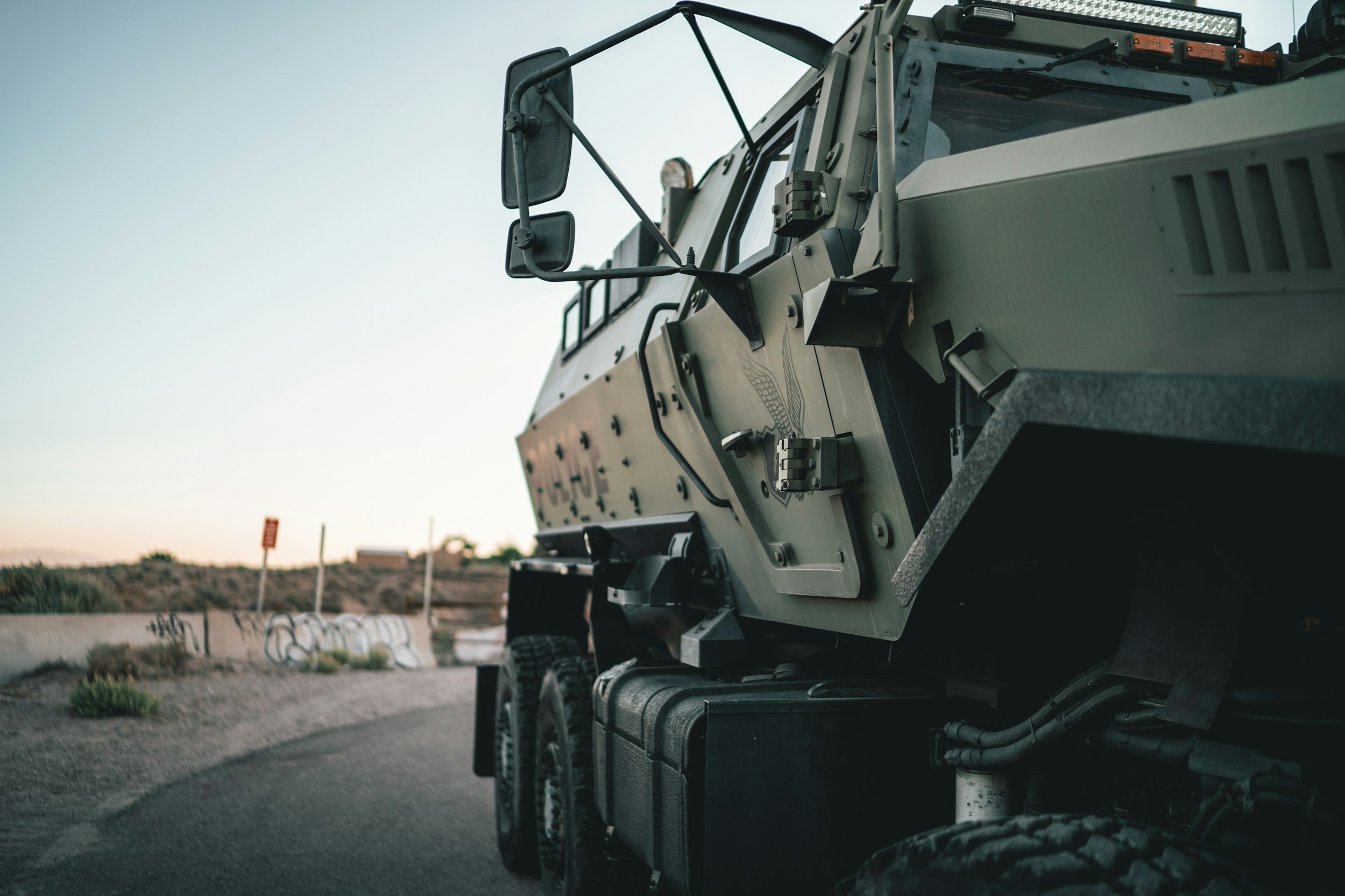 Close-up of a military vehicle or armored truck emphasizing defense / military machining experience.