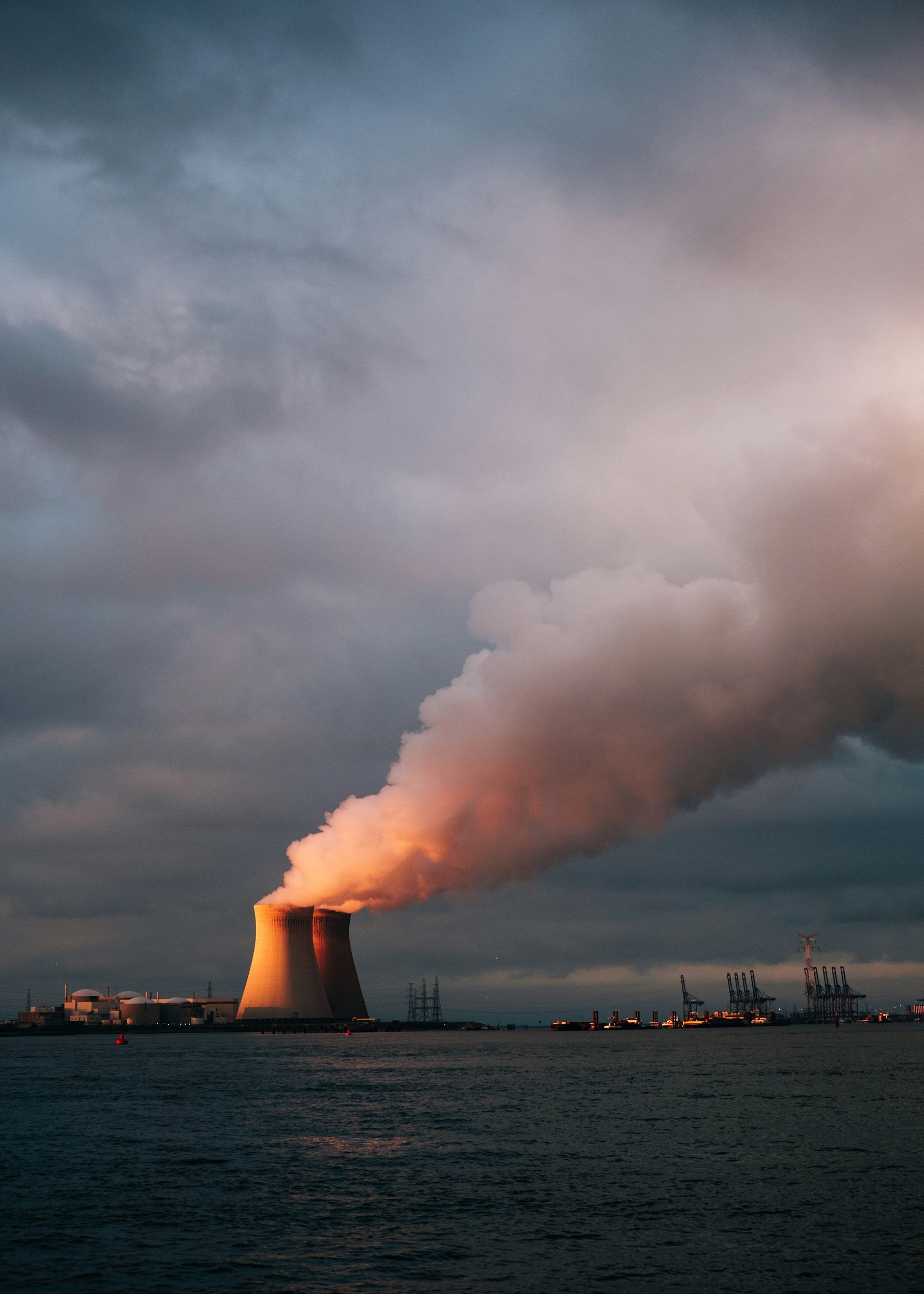 A large cooling tower from a power plant emphasizing energy and nuclear machining experience.