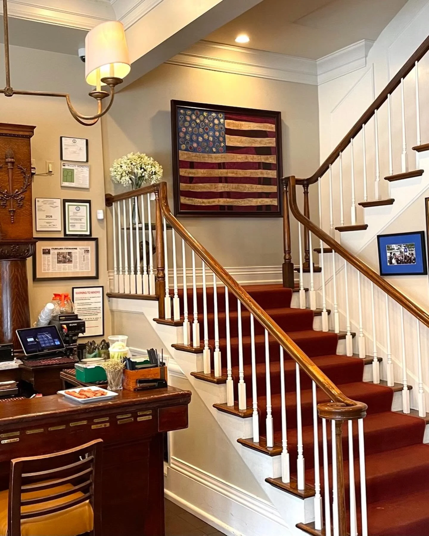 FLAG OF FLOWERS went to Dudley&rsquo;s on Short today &amp; looks so graceful &amp; eye-catching on the landing. Instead of stars, there are flowers representing each state. First stanza of &ldquo;Oh Beautiful&rdquo; written in stripes. Thank you, De