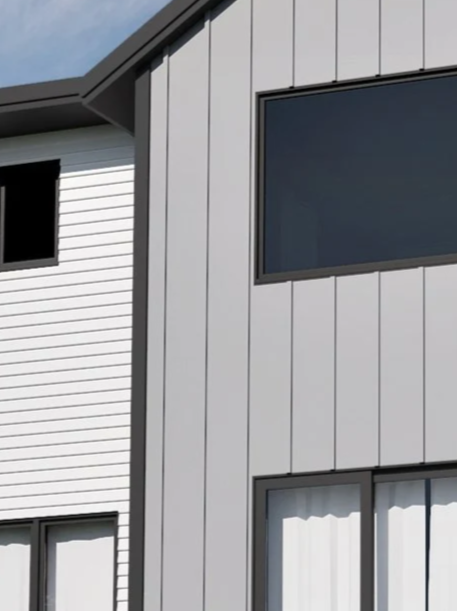 Close-up of modern house exterior with gray vertical siding, white horizontal siding, and large black-framed windows.