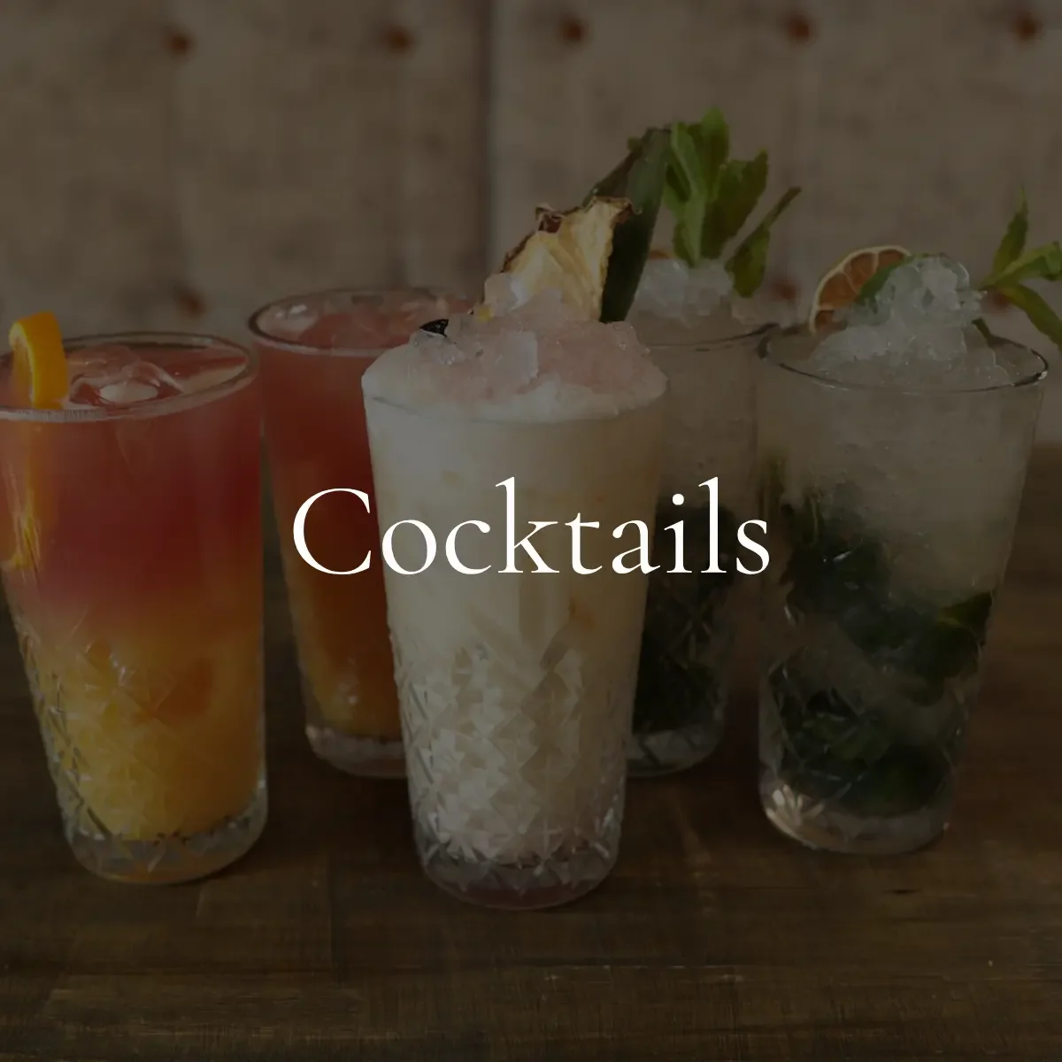 Four colorful cocktails in tall glasses with ice and garnishments, with the word "Cocktails" overlaid.