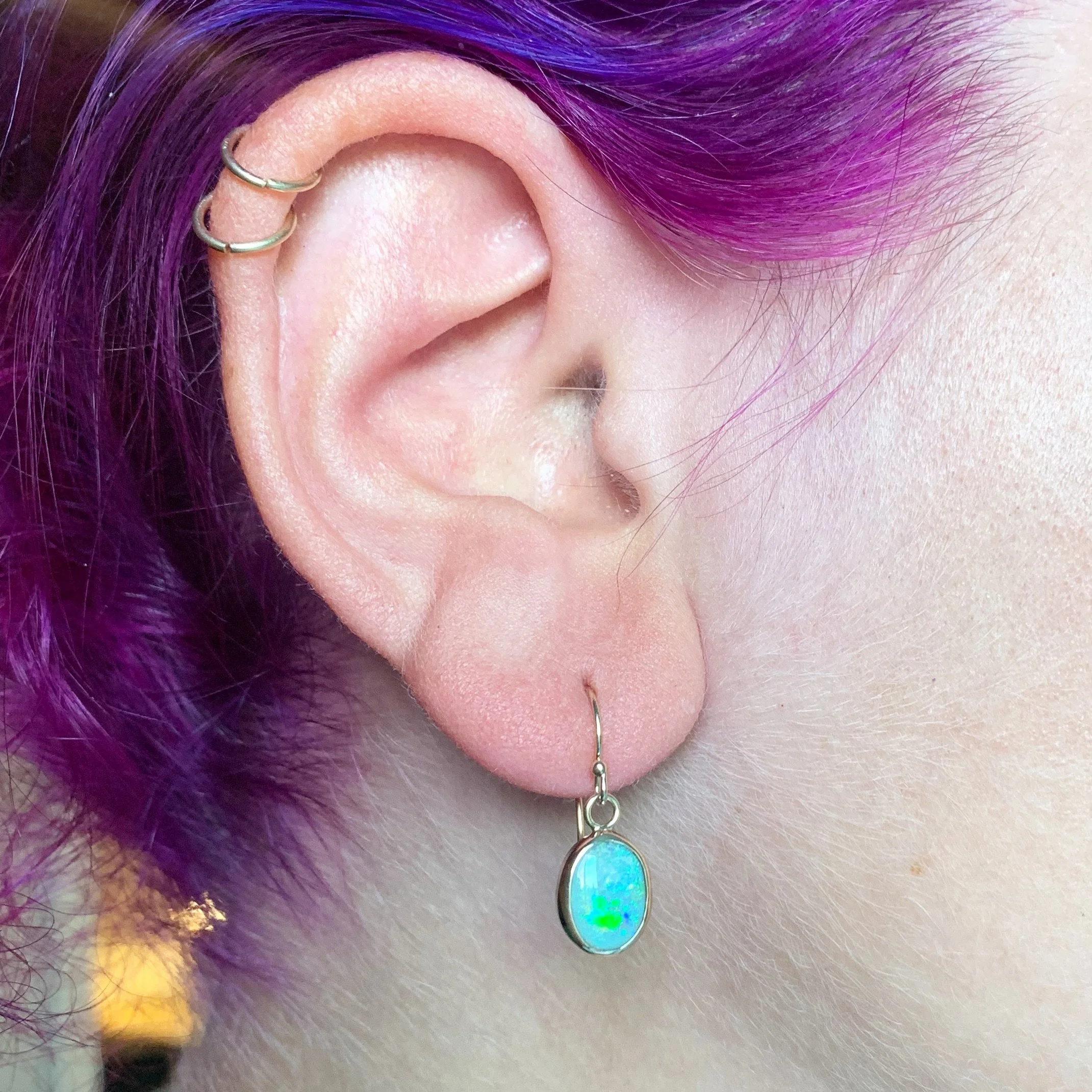 blue and green opal set in 14k yellow gold dangly earring