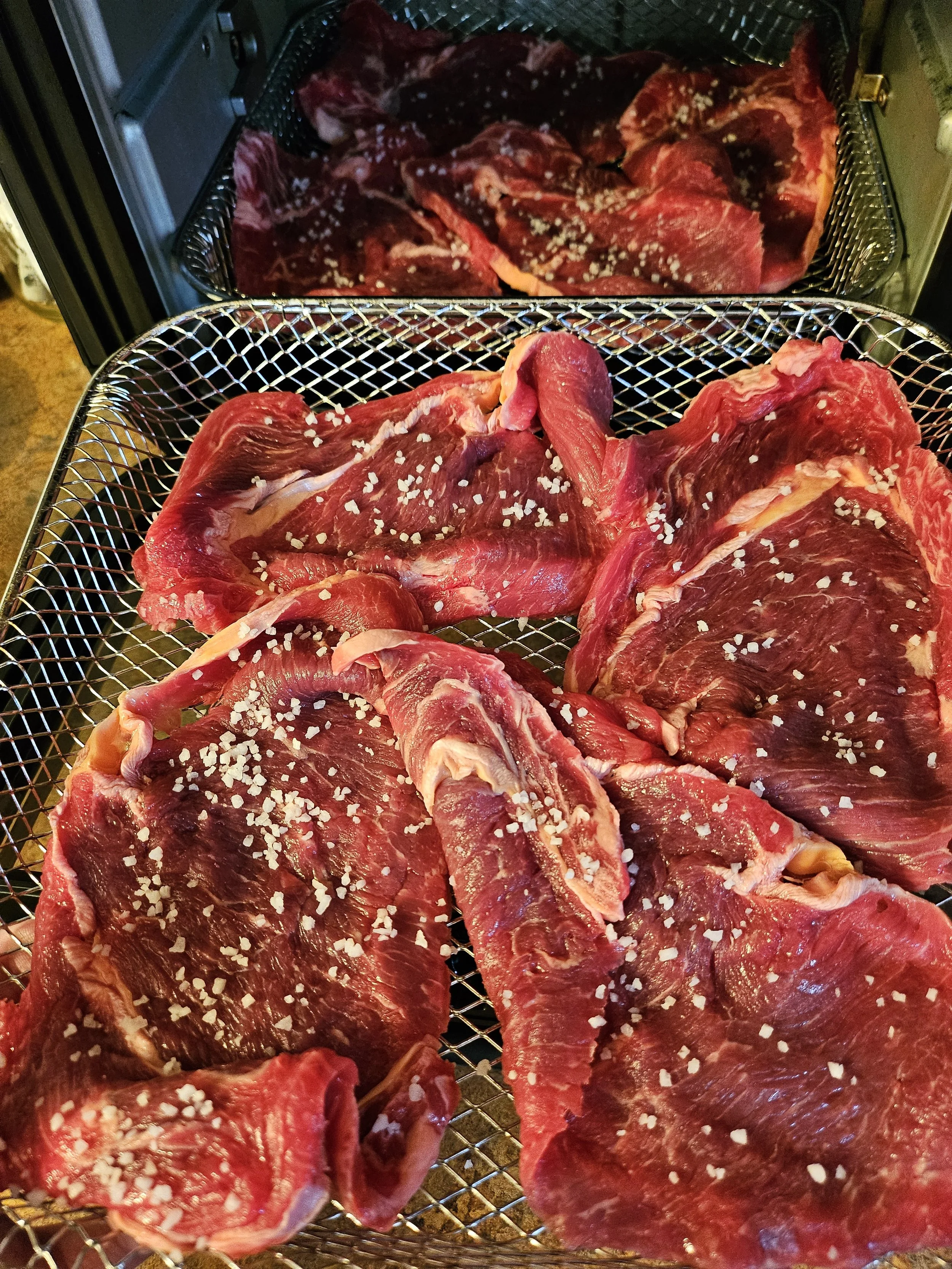 Lay the meat in your dehydrator. Salt and season as desired.