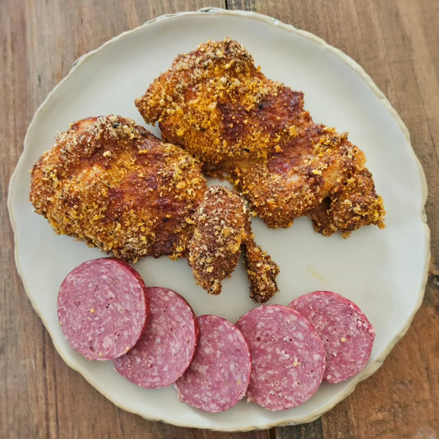 One of my all-time favorite meal combos! Fried chicken thighs coated in a blend of quail eggs &amp; Frank's red hot and "breaded" with @porkkinggood Cajun pork rind crumbs + a helping of @sevensonsfarms beef summer sausage. Crunchy, fatty, 