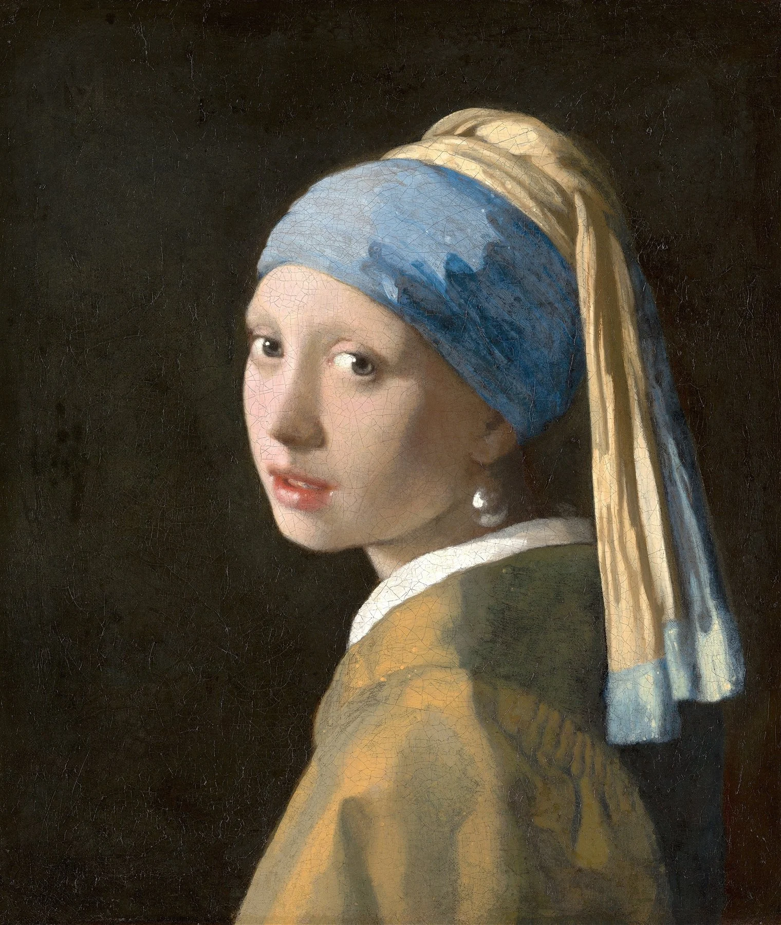 Close-up of a young girl with blue headscarf, smiling slightly, with a dark background.
