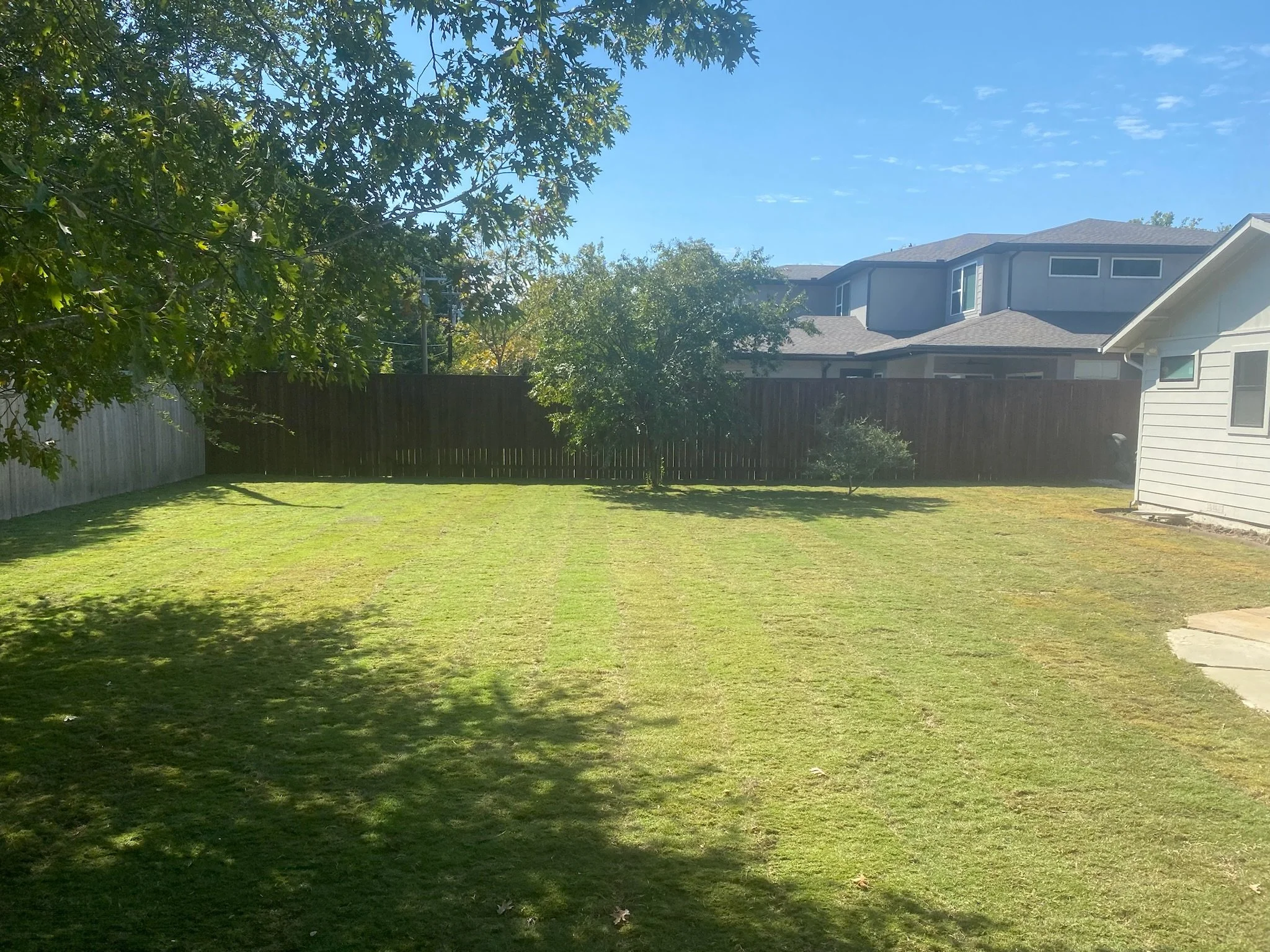 After: professionally graded yard with new Bermuda sod for a clean, healthy lawn