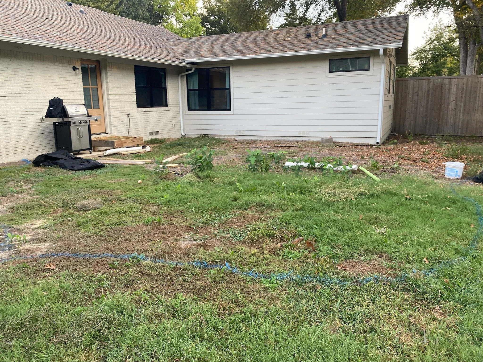 Before: uneven Dallas TX yard before patio and grading work