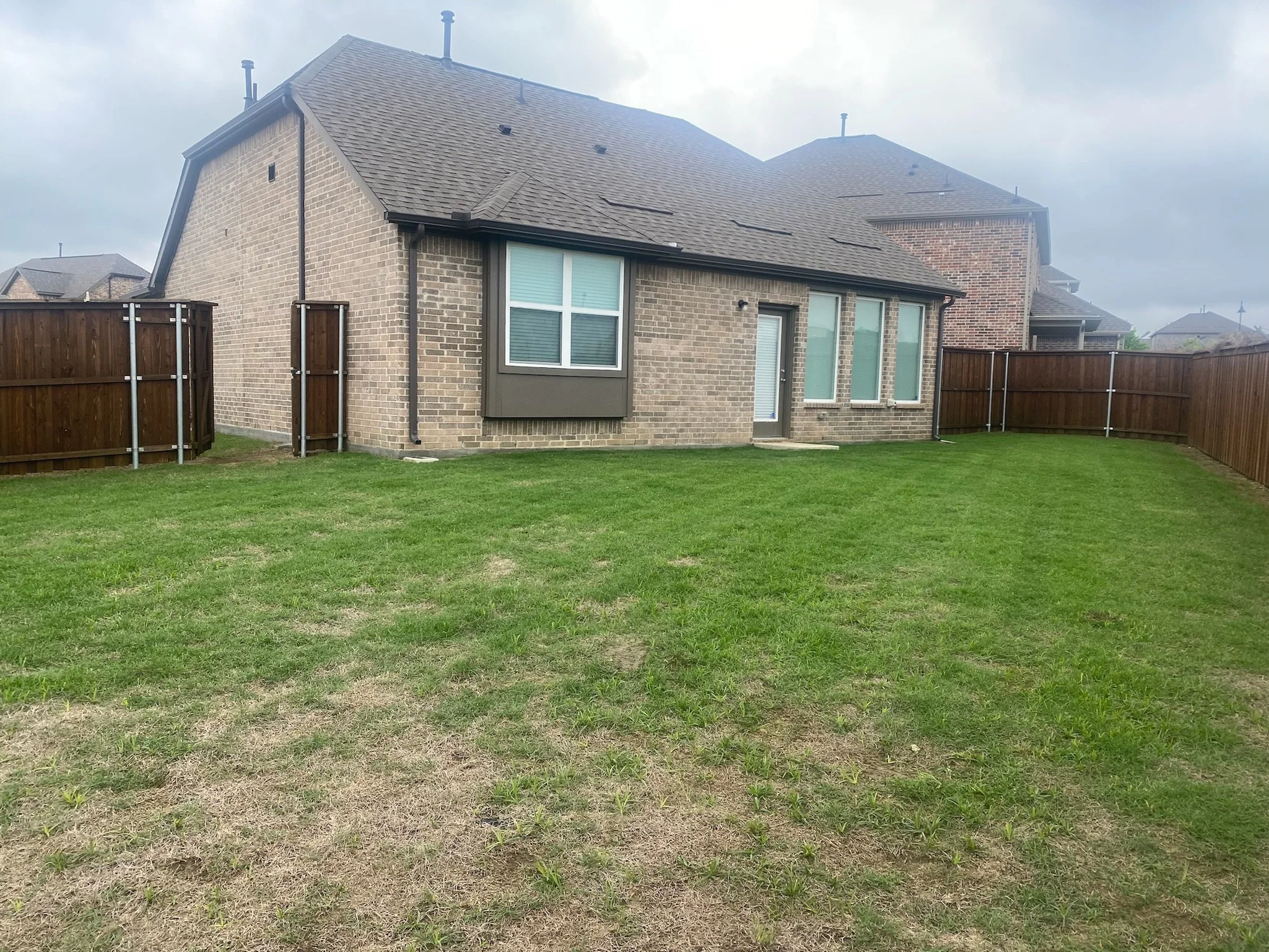 Before photo of a patchy, uneven lawn in need of fertilization treatment in Garland, TX.