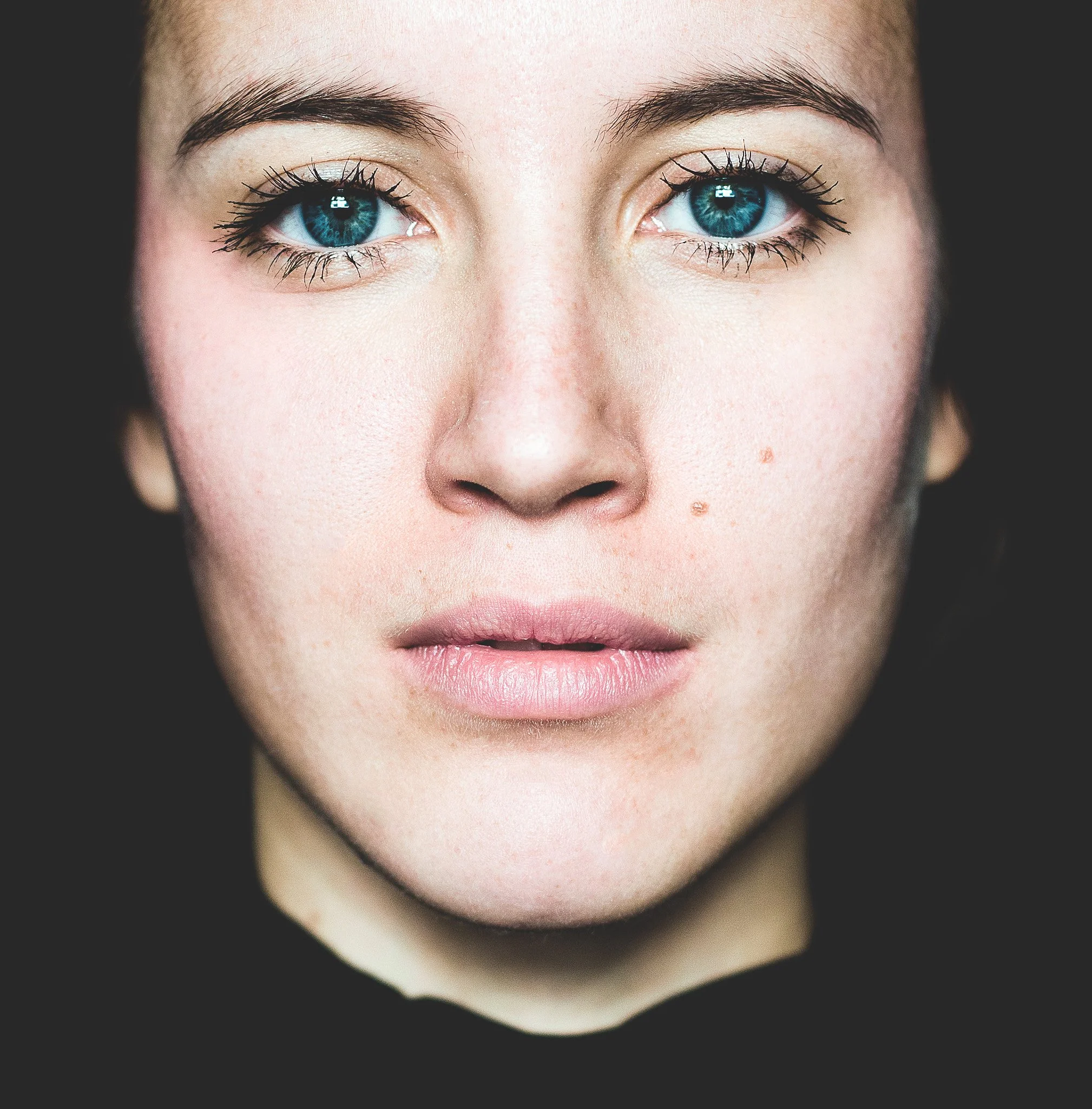Close-up of a woman's face with blue eyes, medium complexion, and natural makeup.