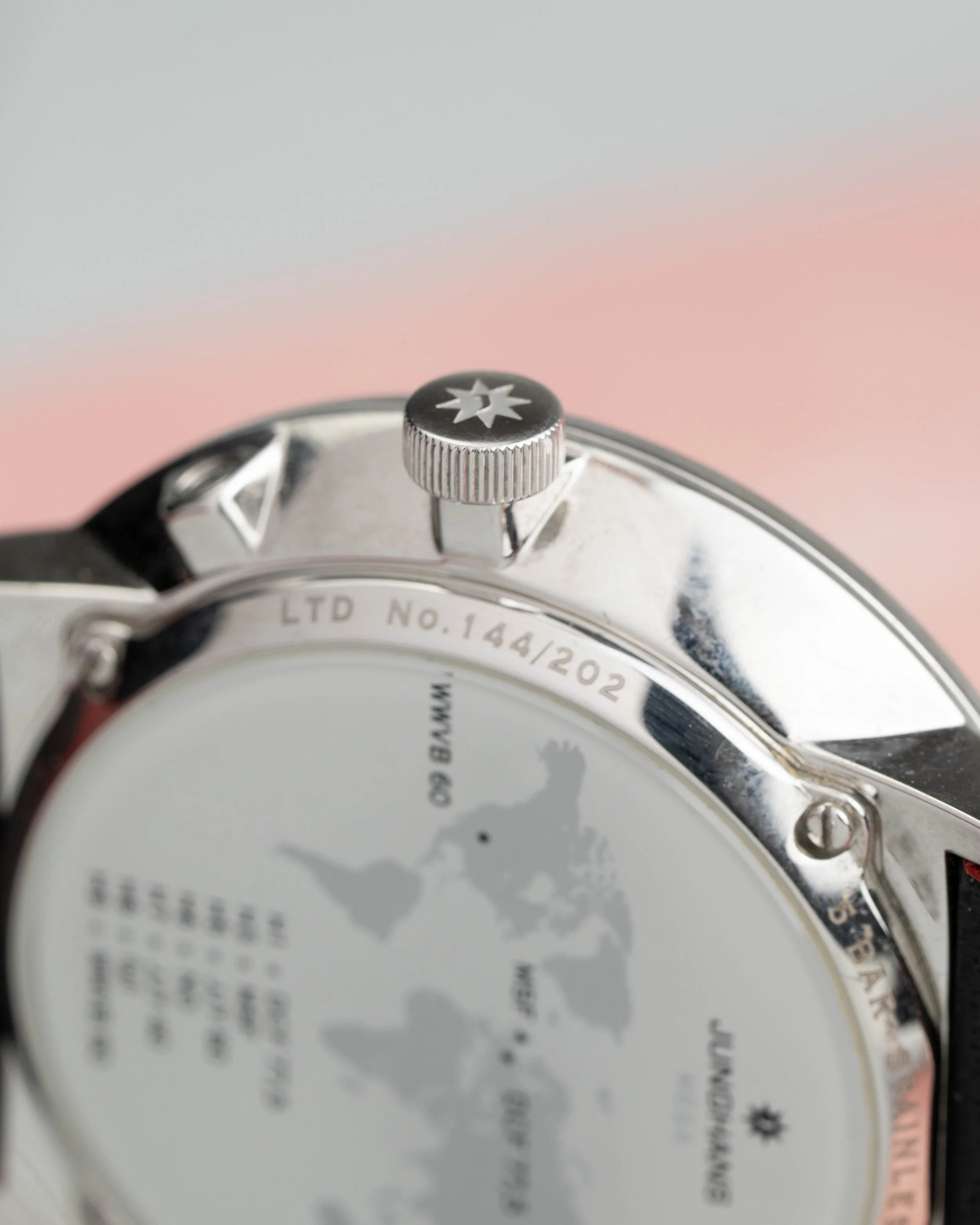 Modern Bauhaus style Junghans watch. Minimalist white dial design with red detailing and high-tech radio control accuracy