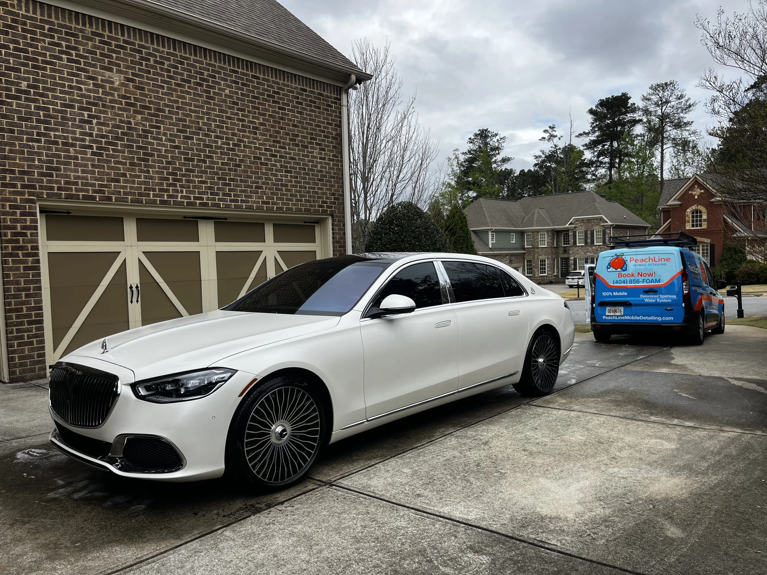 detailed-mercedes-sedan-next-to-a-mobile-detailing-van