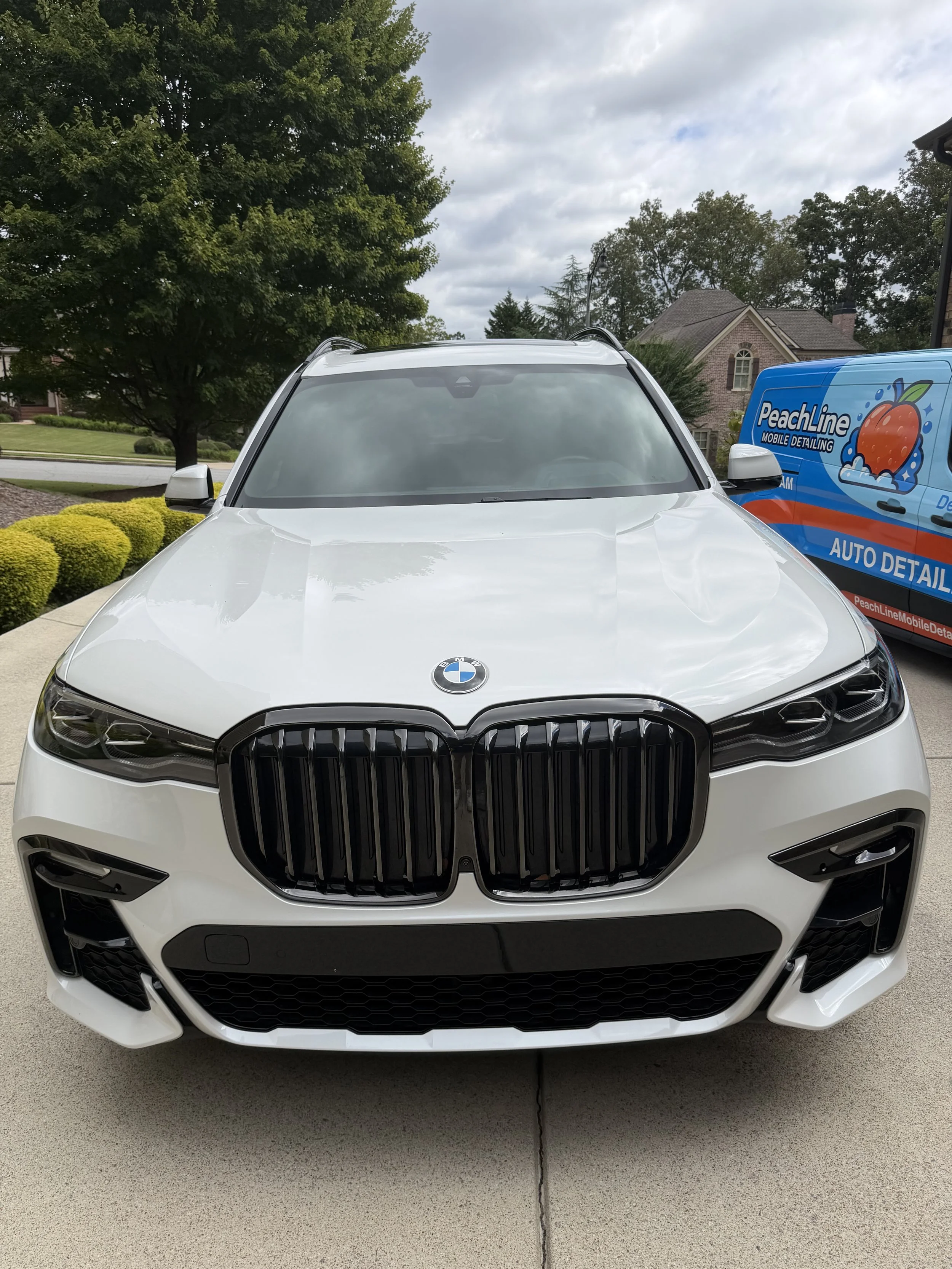 Customer paying for mobile car detailing after final inspection