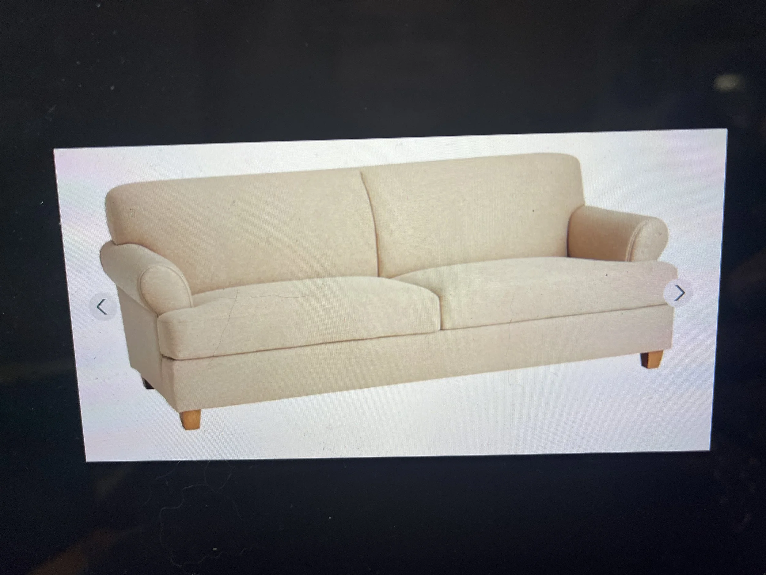 Rooms to Go beige sofa with wooden legs. - rental only